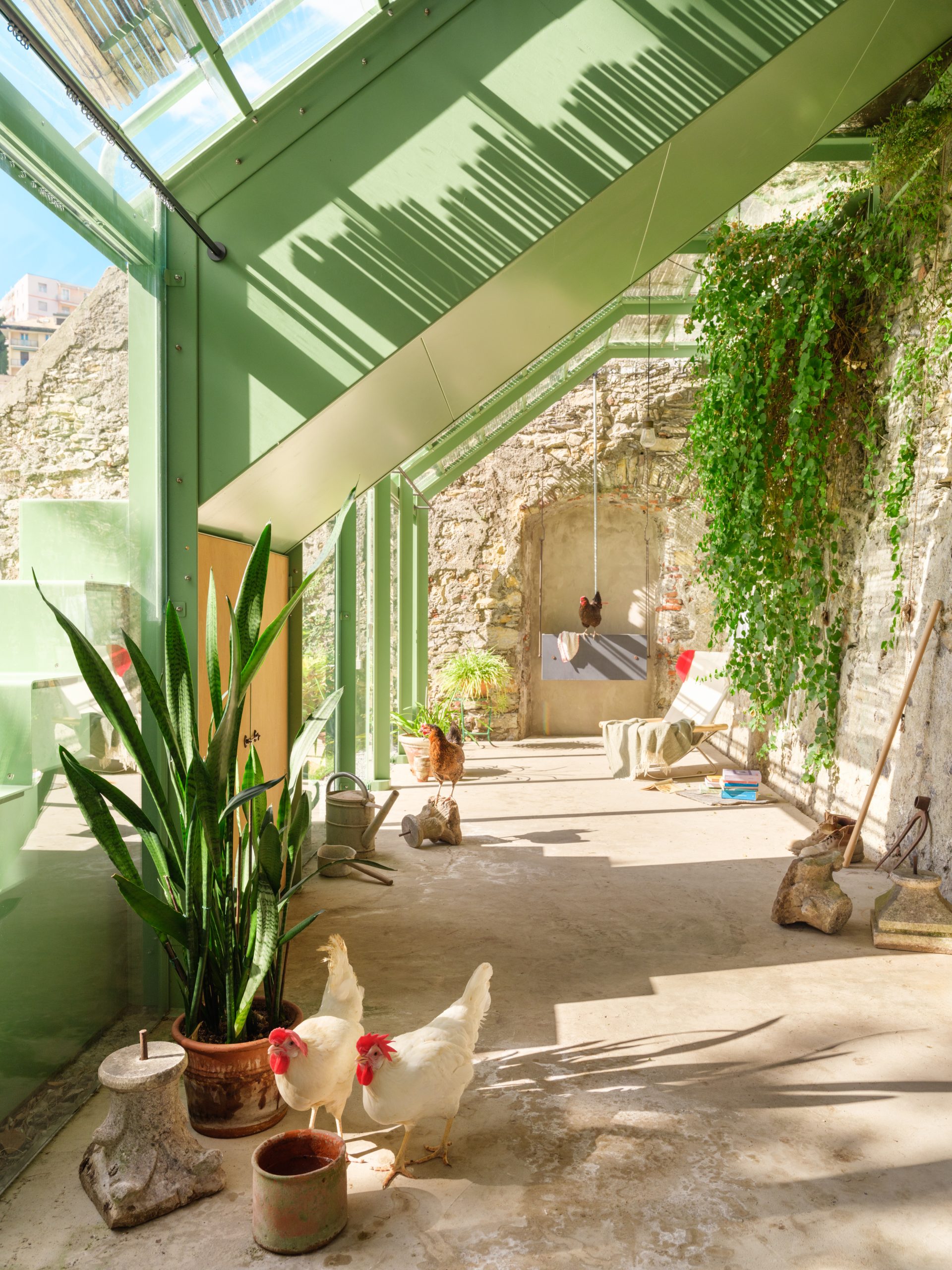 Transparent greenhouse structure immersed in vegetation