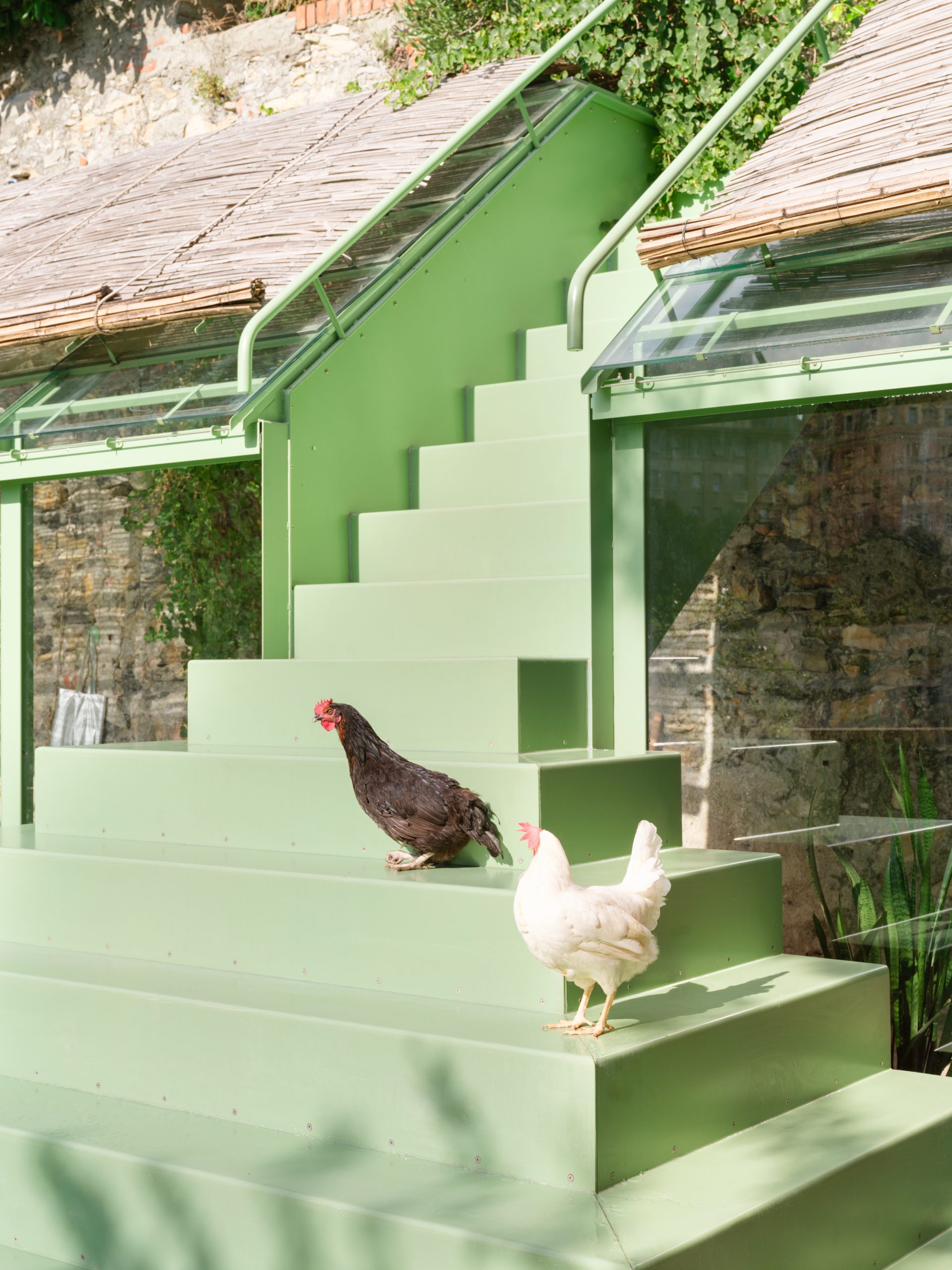 Greenhouse interior with bespoke furniture and garden views