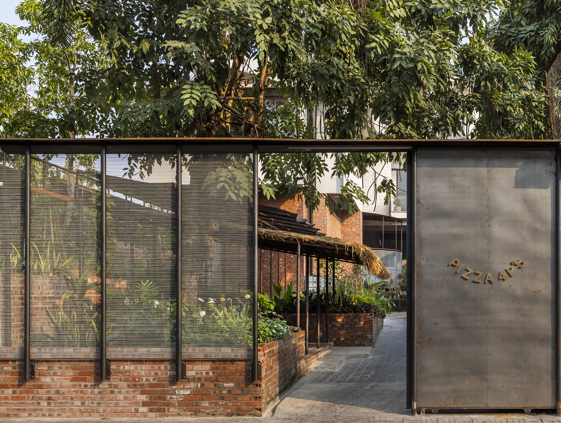 Entrance gate framed by tropical planting