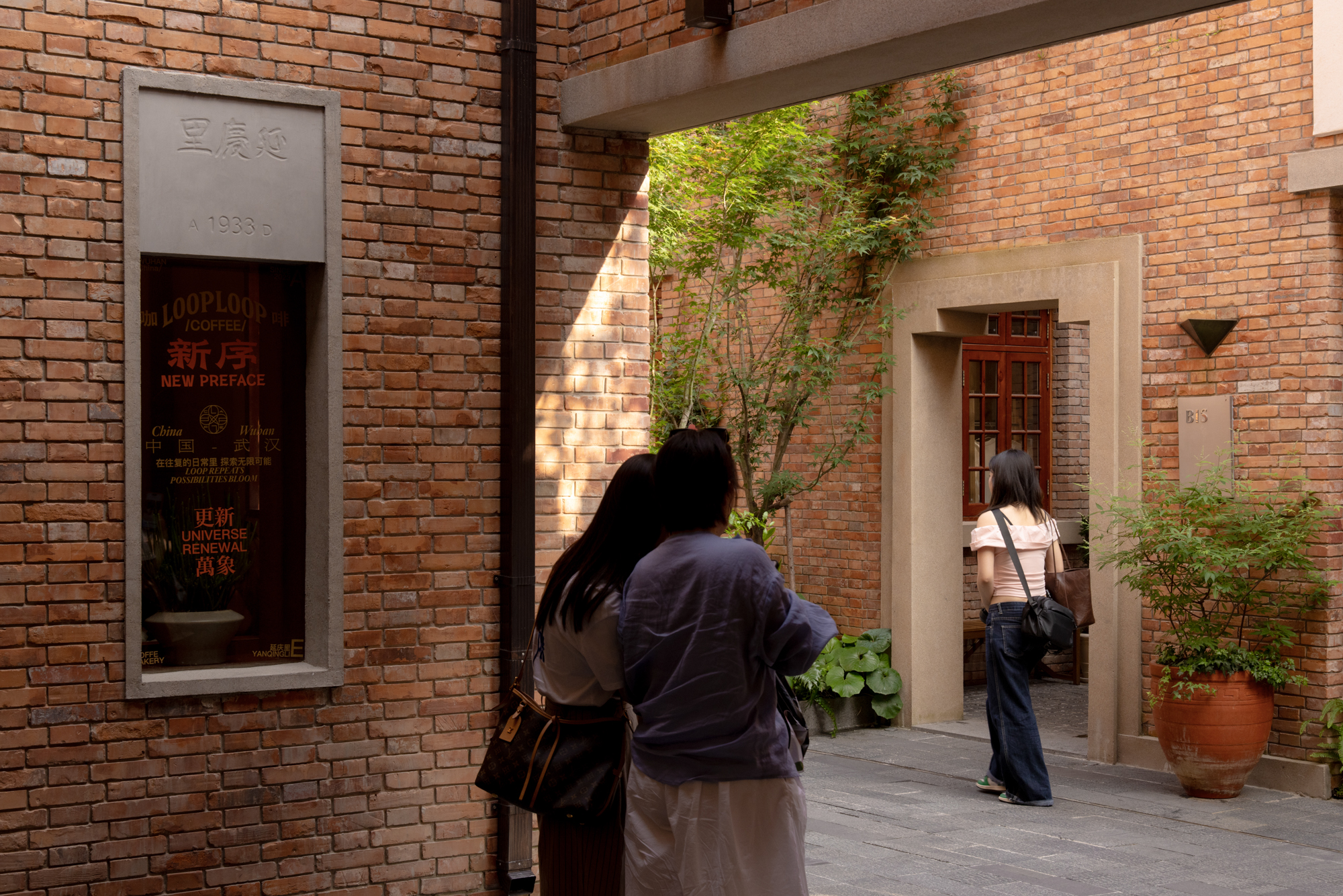 Historic walls and new circulation overlap inside the renovated block