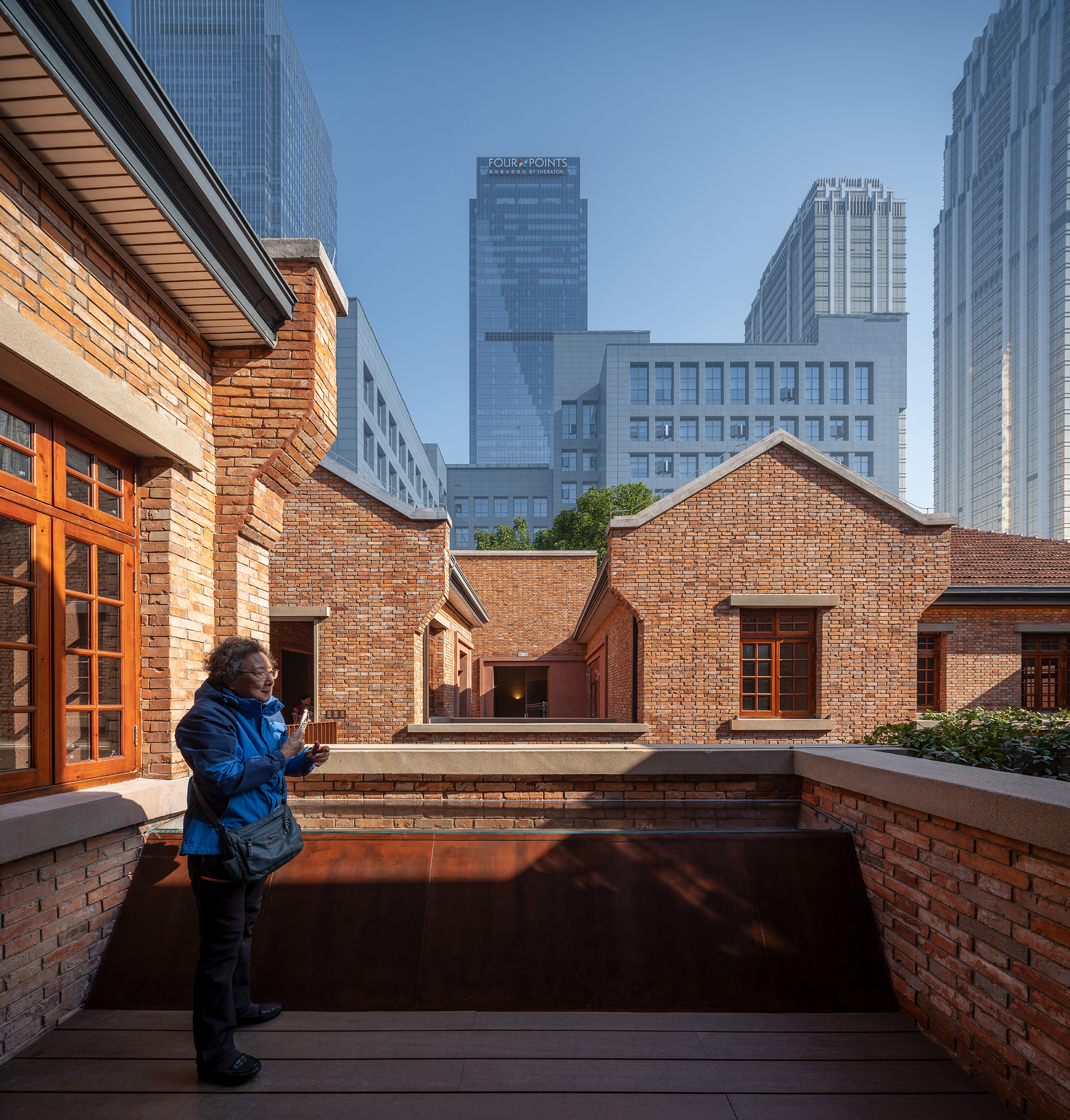 A terrace beside Building 3 extends the public promenade above ground