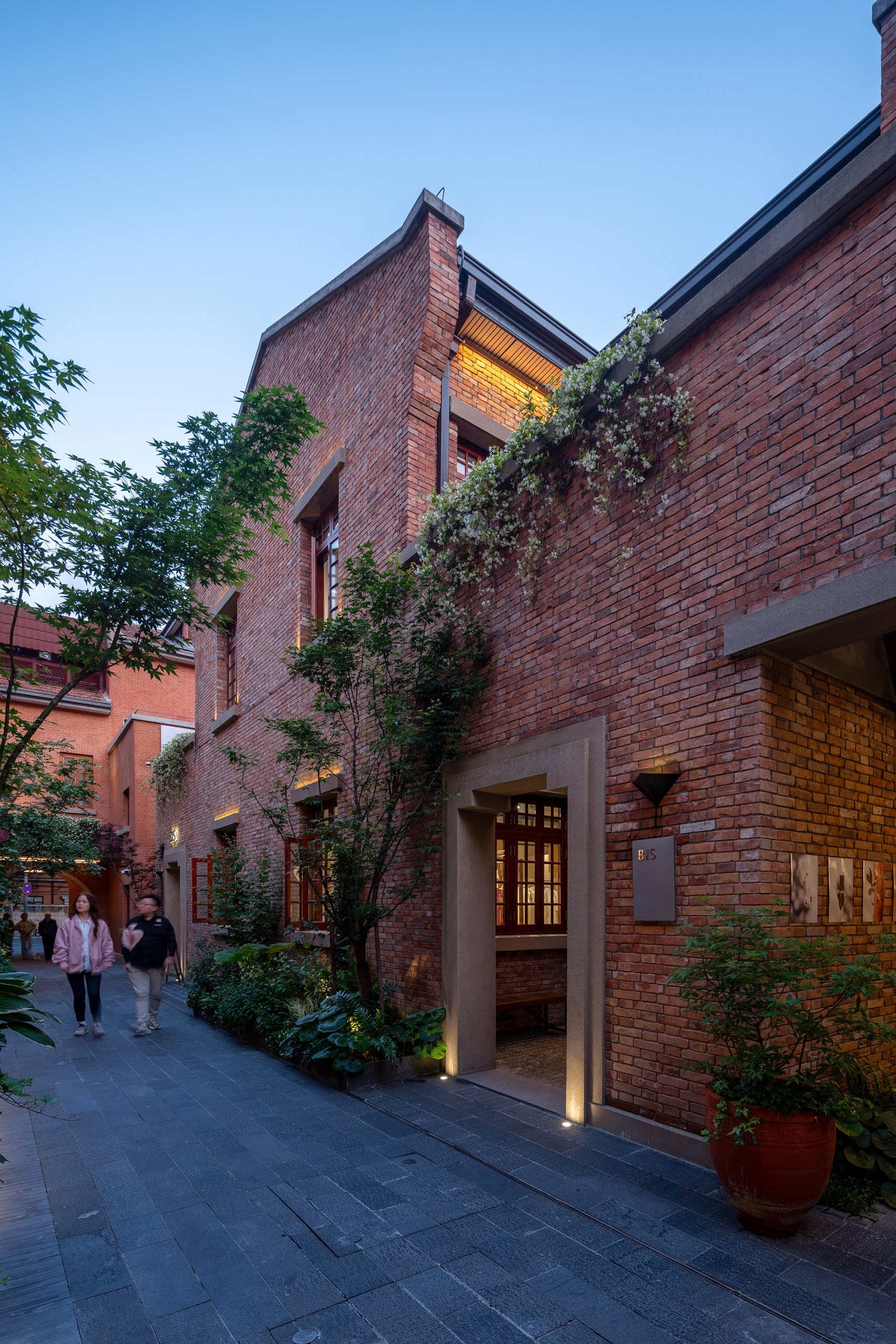 Shops illuminate the primary alley after dark
