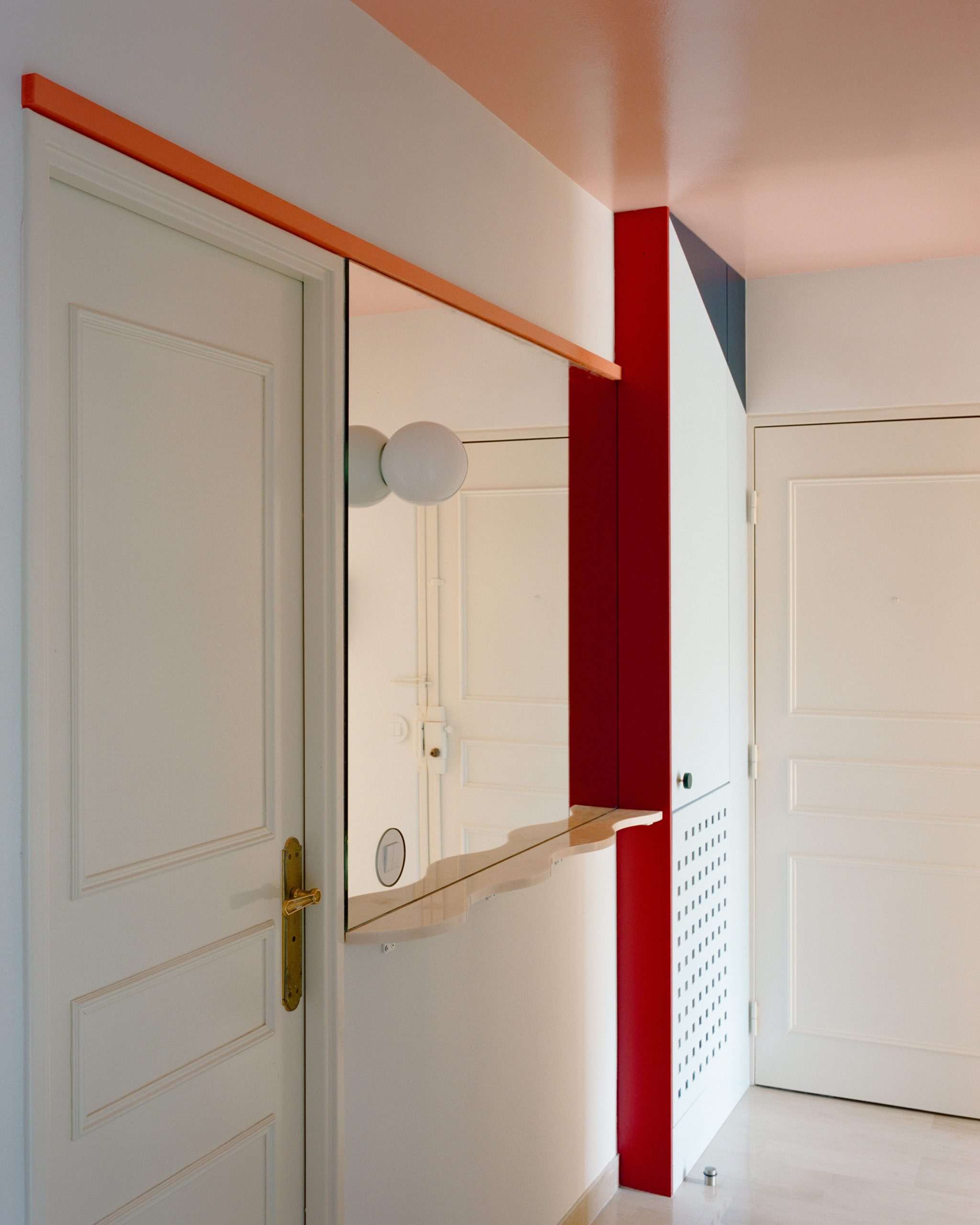Entrance view showing layered surfaces in the Fabron apartment
