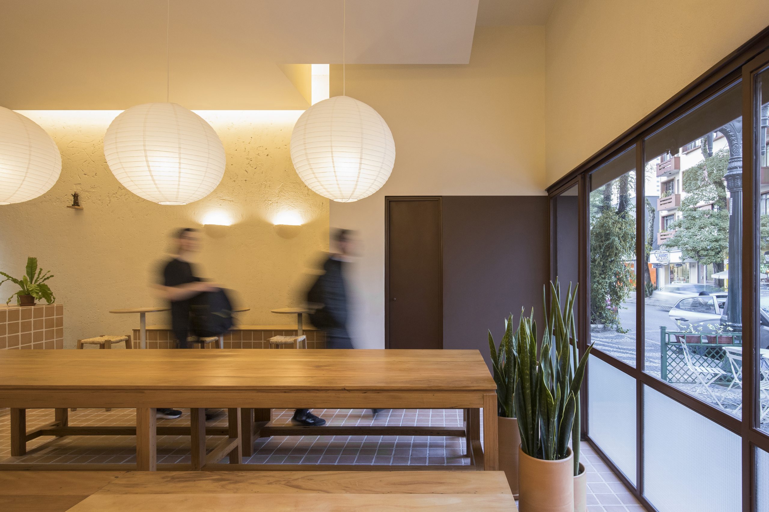 Round tables and built-in benches at Banca Padre Pio