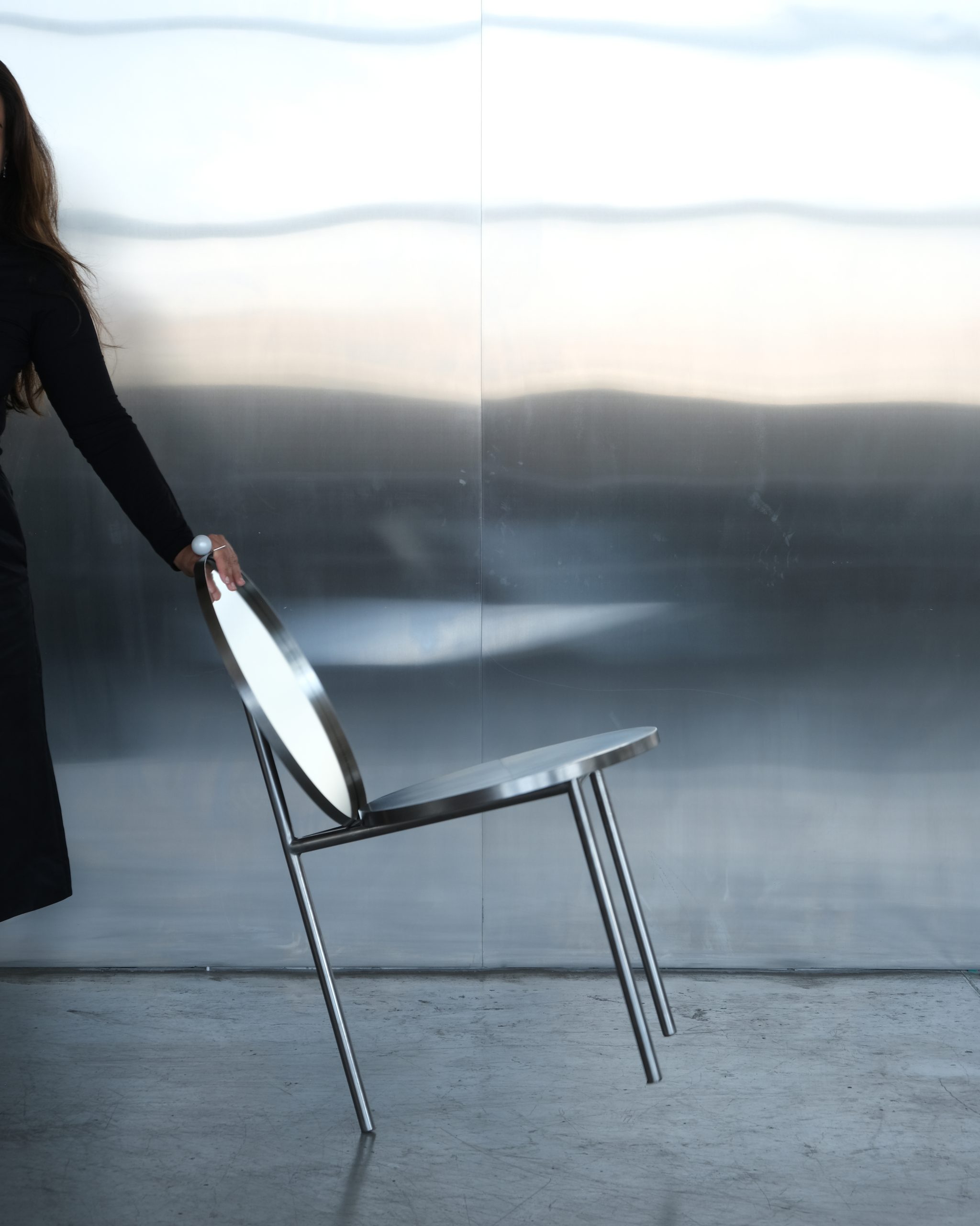 Mirror inset into the backrest of the Woman's Chair