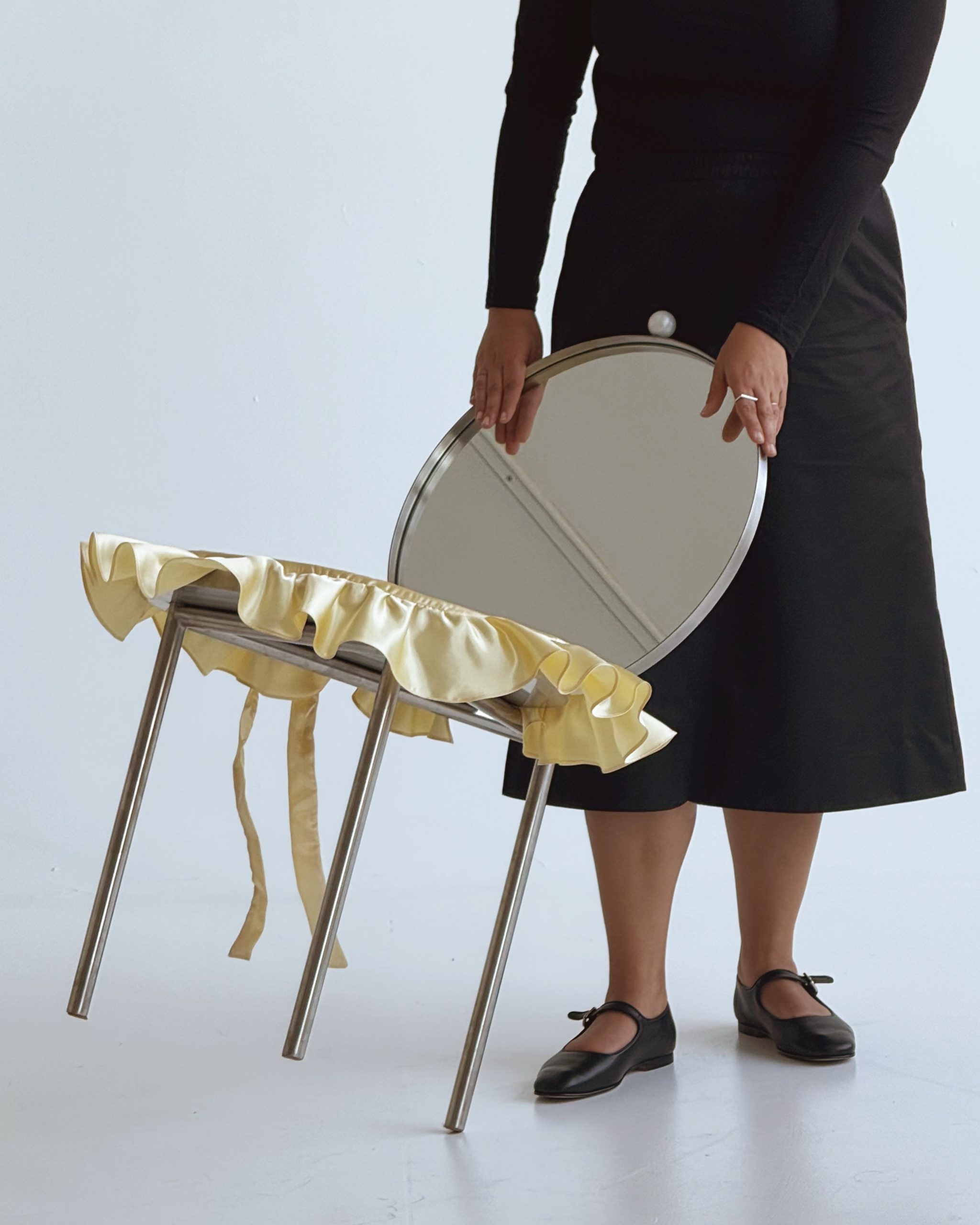 Three stainless steel legs create deliberate instability