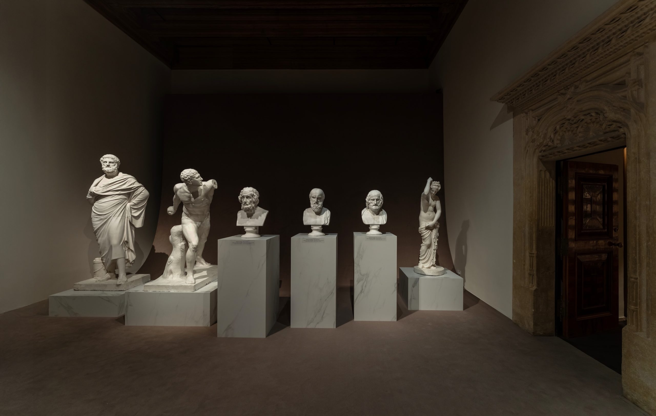 Plaster casts displayed on marble pedestals at Wawel Royal Castle