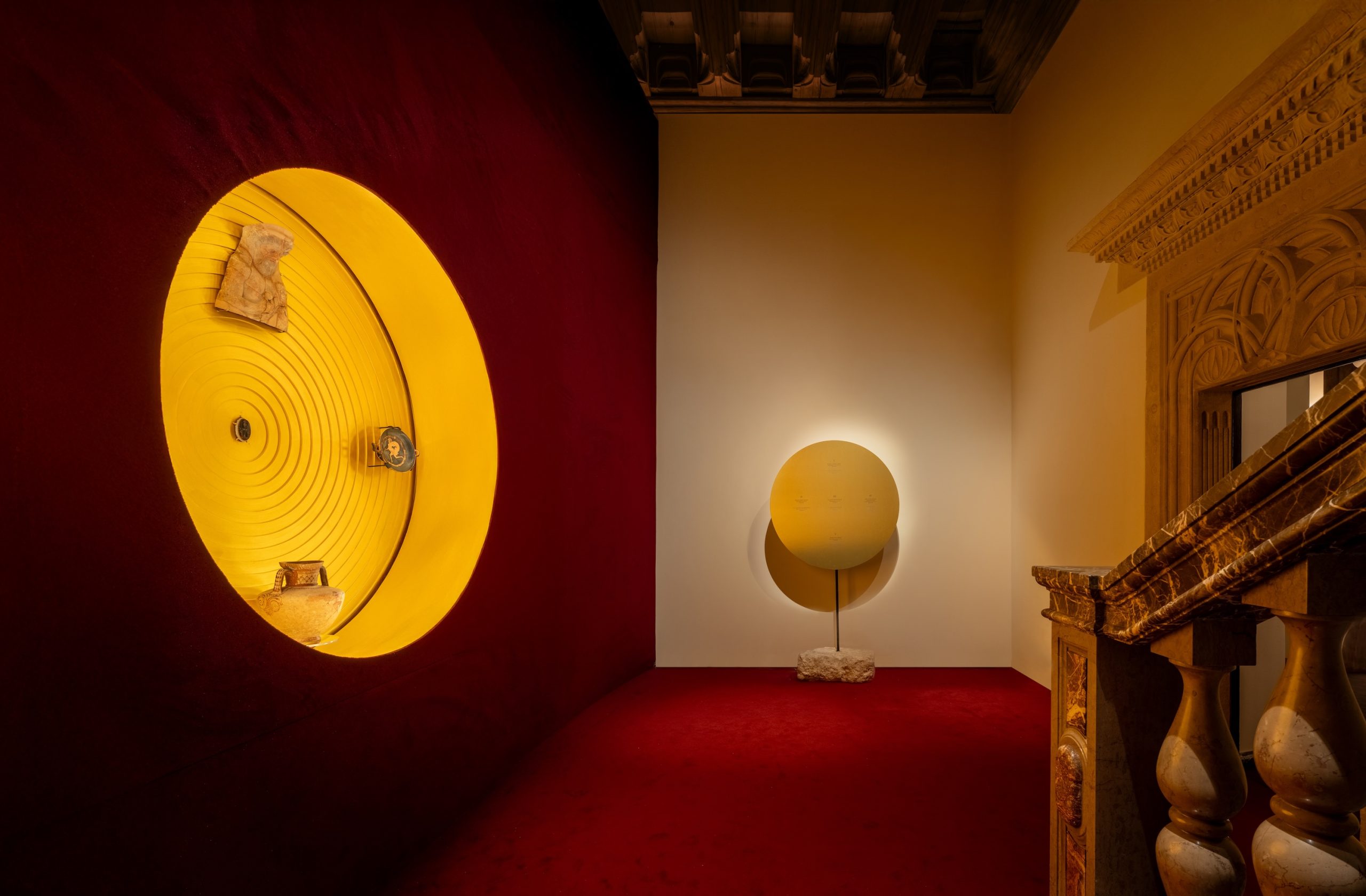 Curved burgundy wall in the final exhibition room