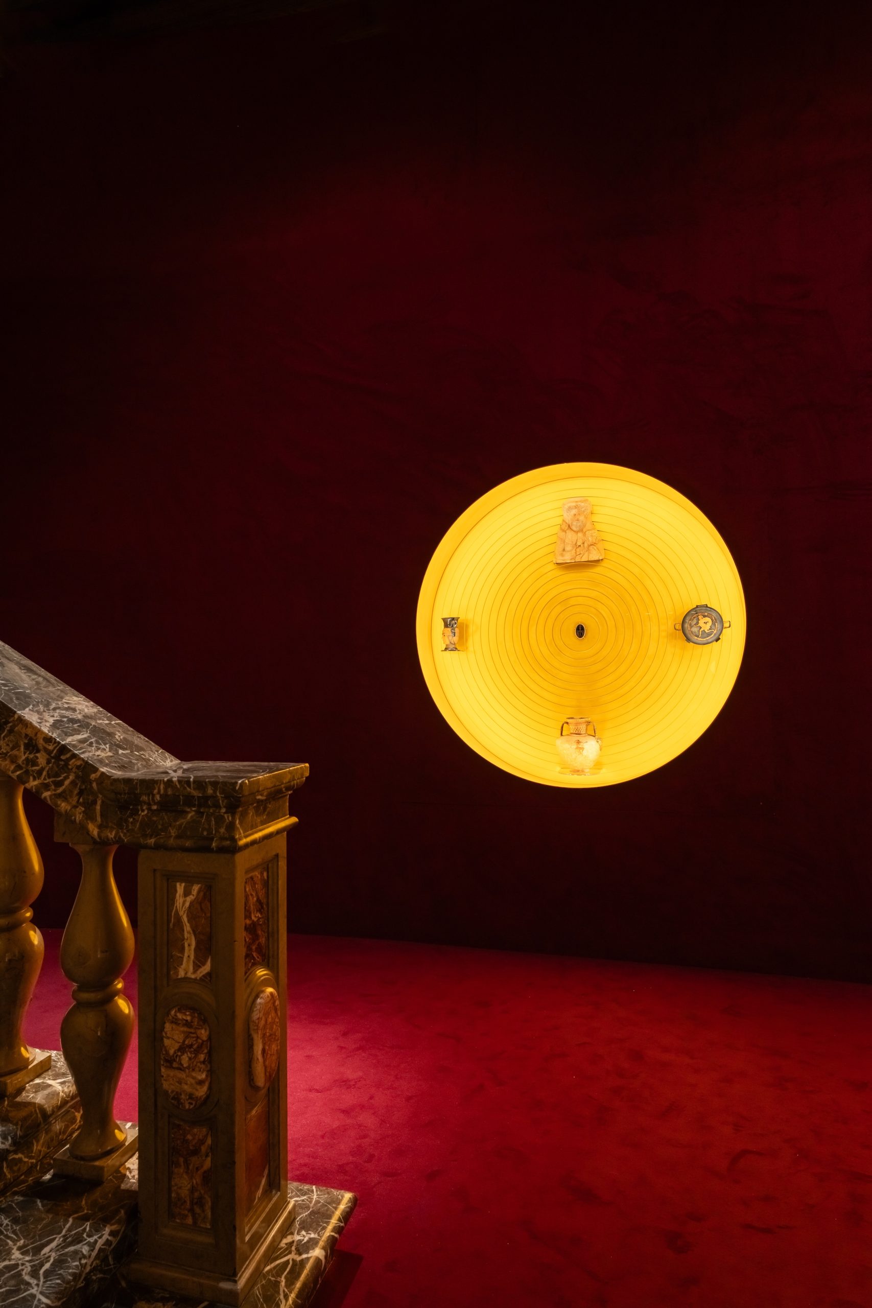 Concentric brass display case illuminated by diffused light