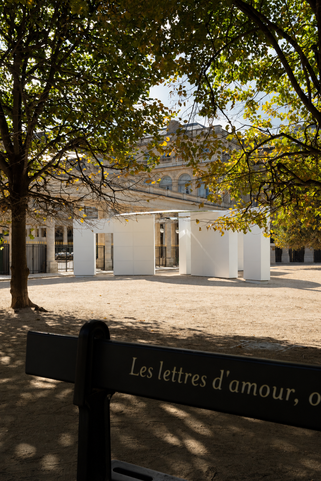 The temporary installation is visible through the garden’s trees.