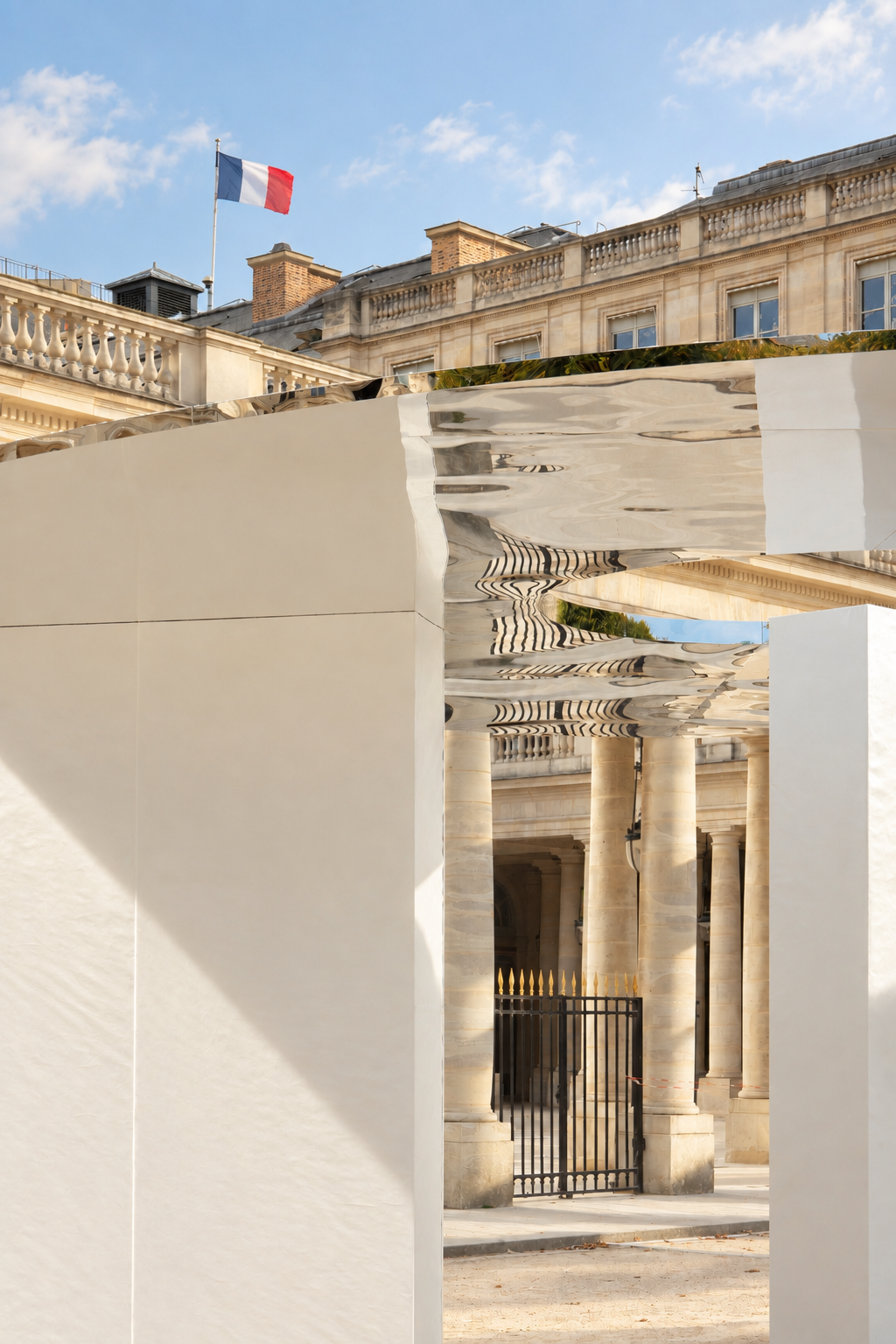 A wall opening frames the colonnade beneath the mirrored roof.