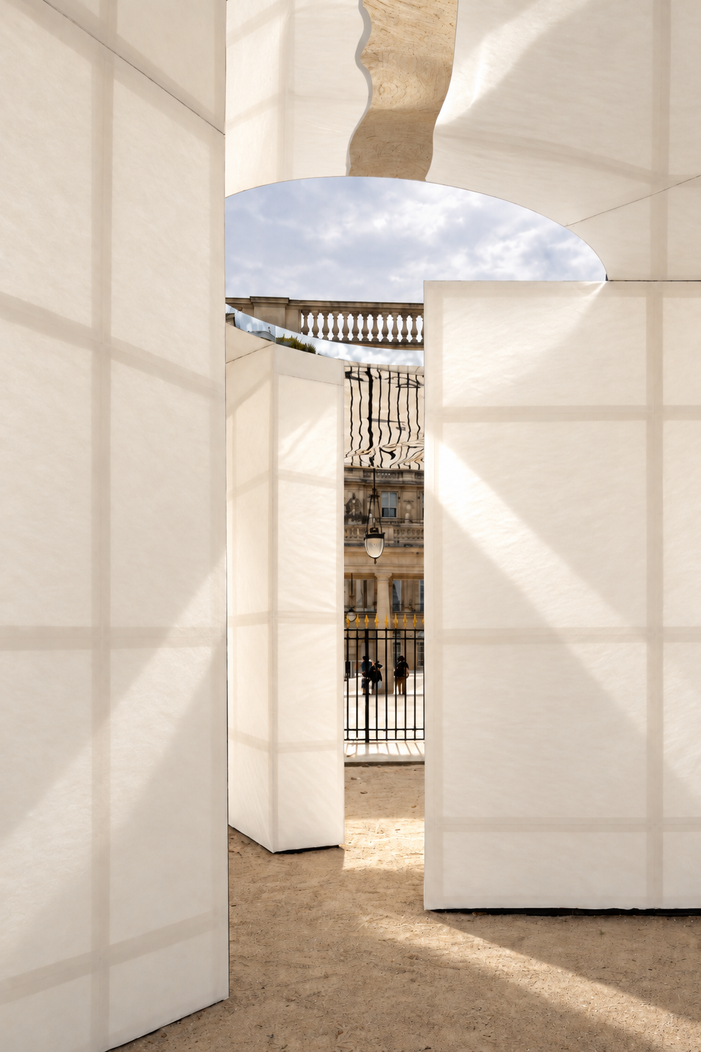 A circular roof opening admits sunlight between the translucent walls.