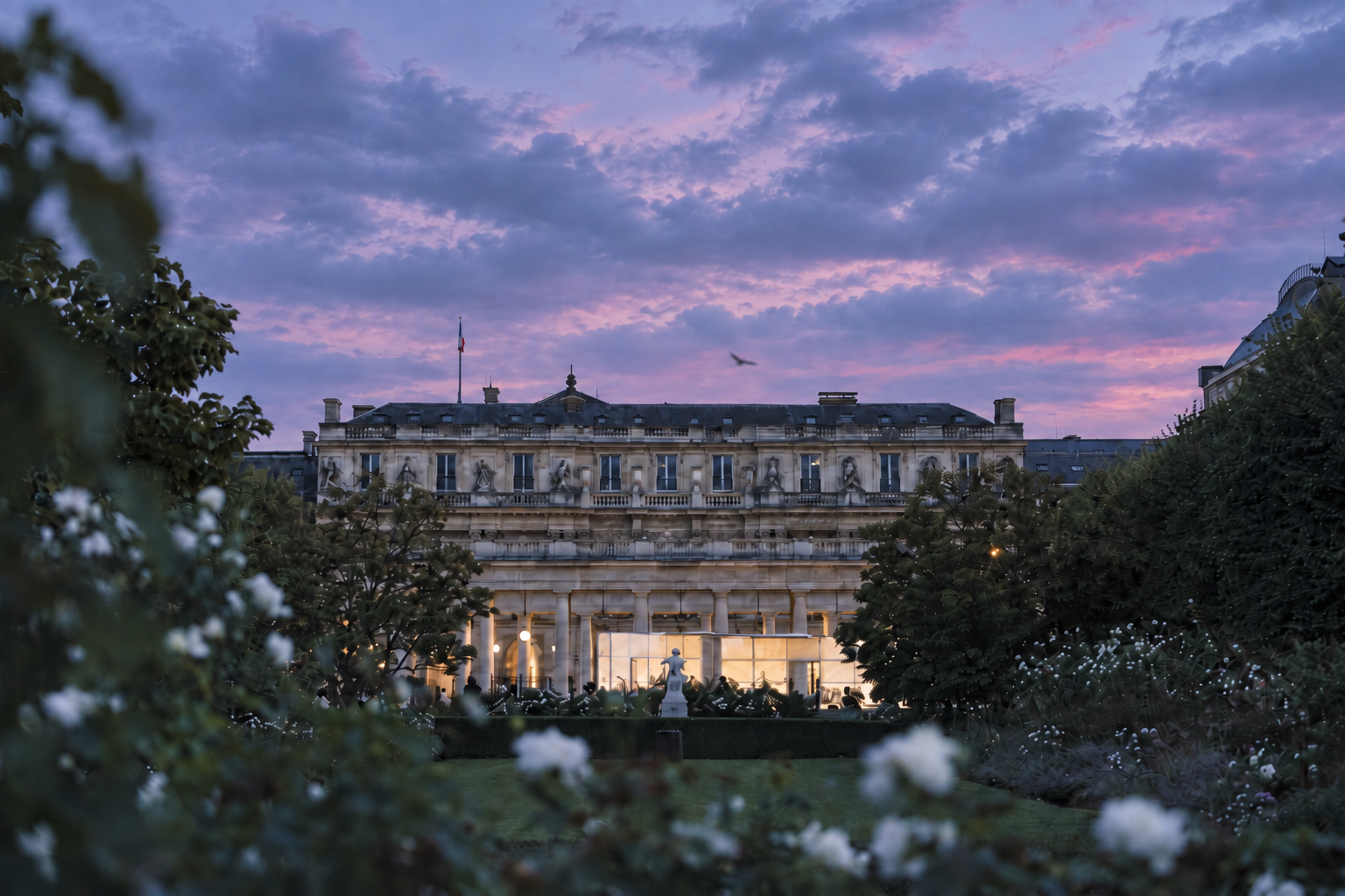The Palais-Royal garden and pavilion at dusk.