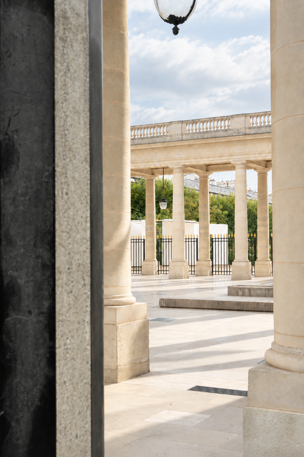 The pavilion is seen between the columns of the historic building.
