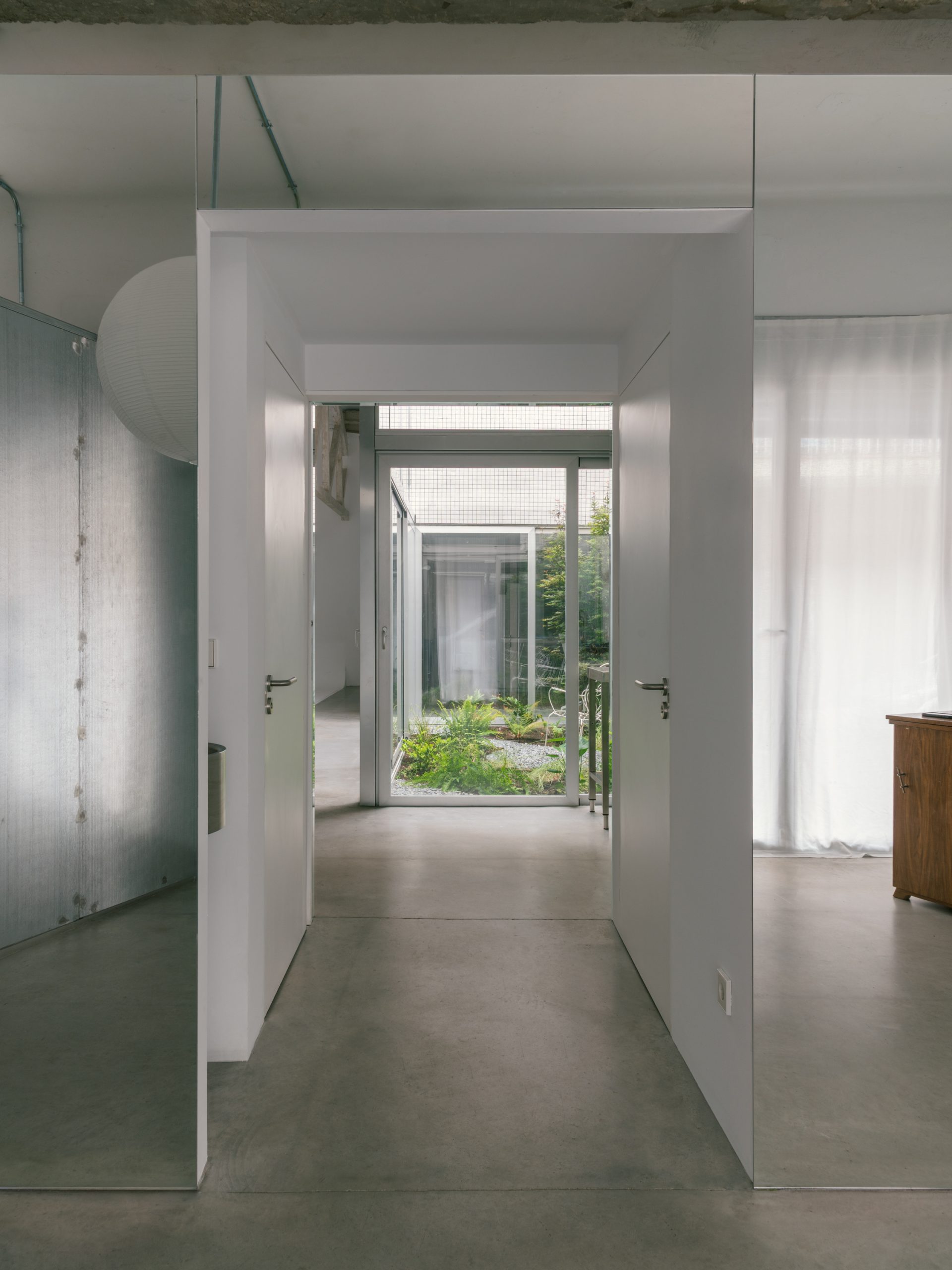A view through the entrance aligns with the courtyard beyond.
