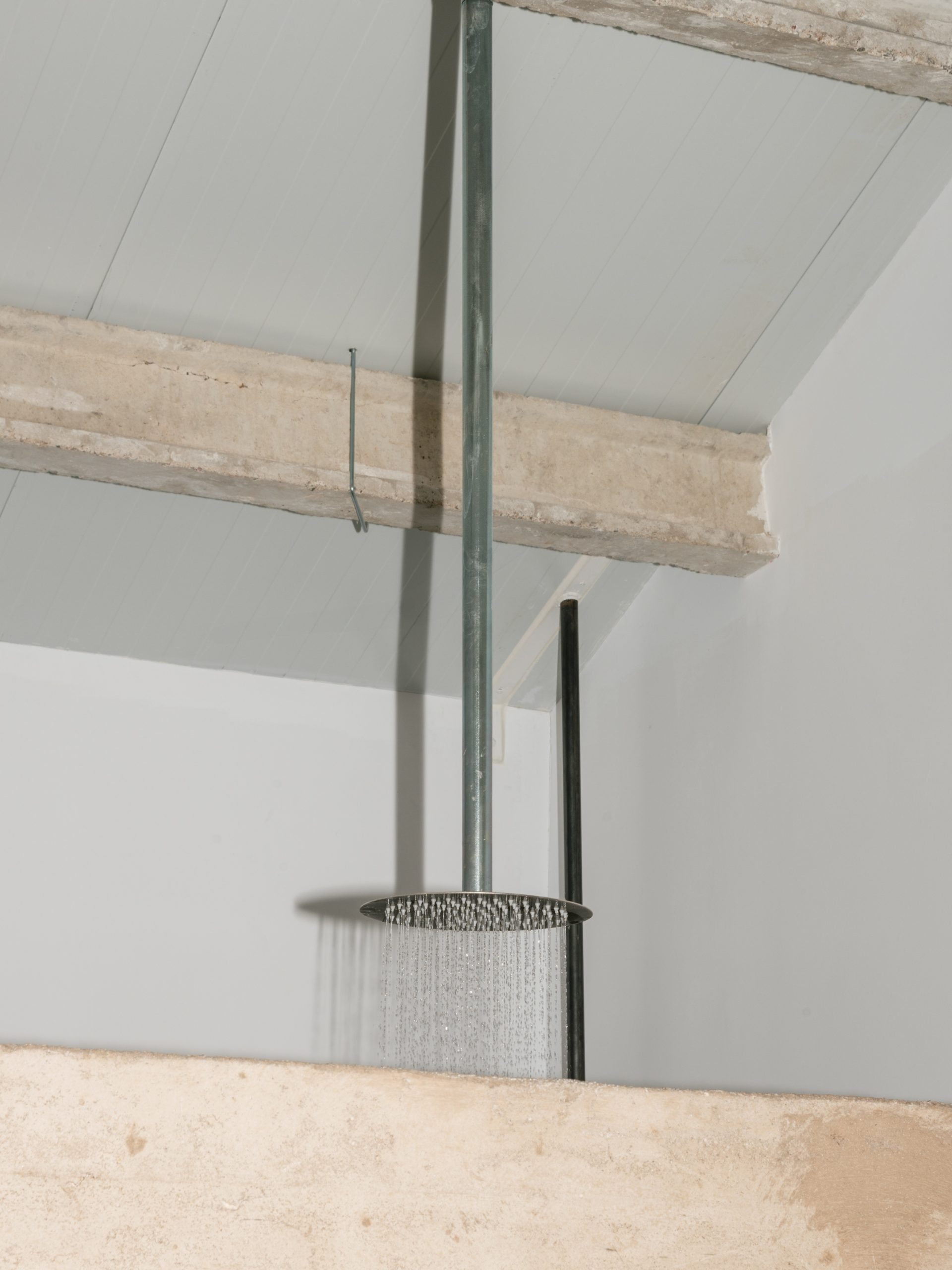 Glazing and exposed concrete meet at the shower enclosure.
