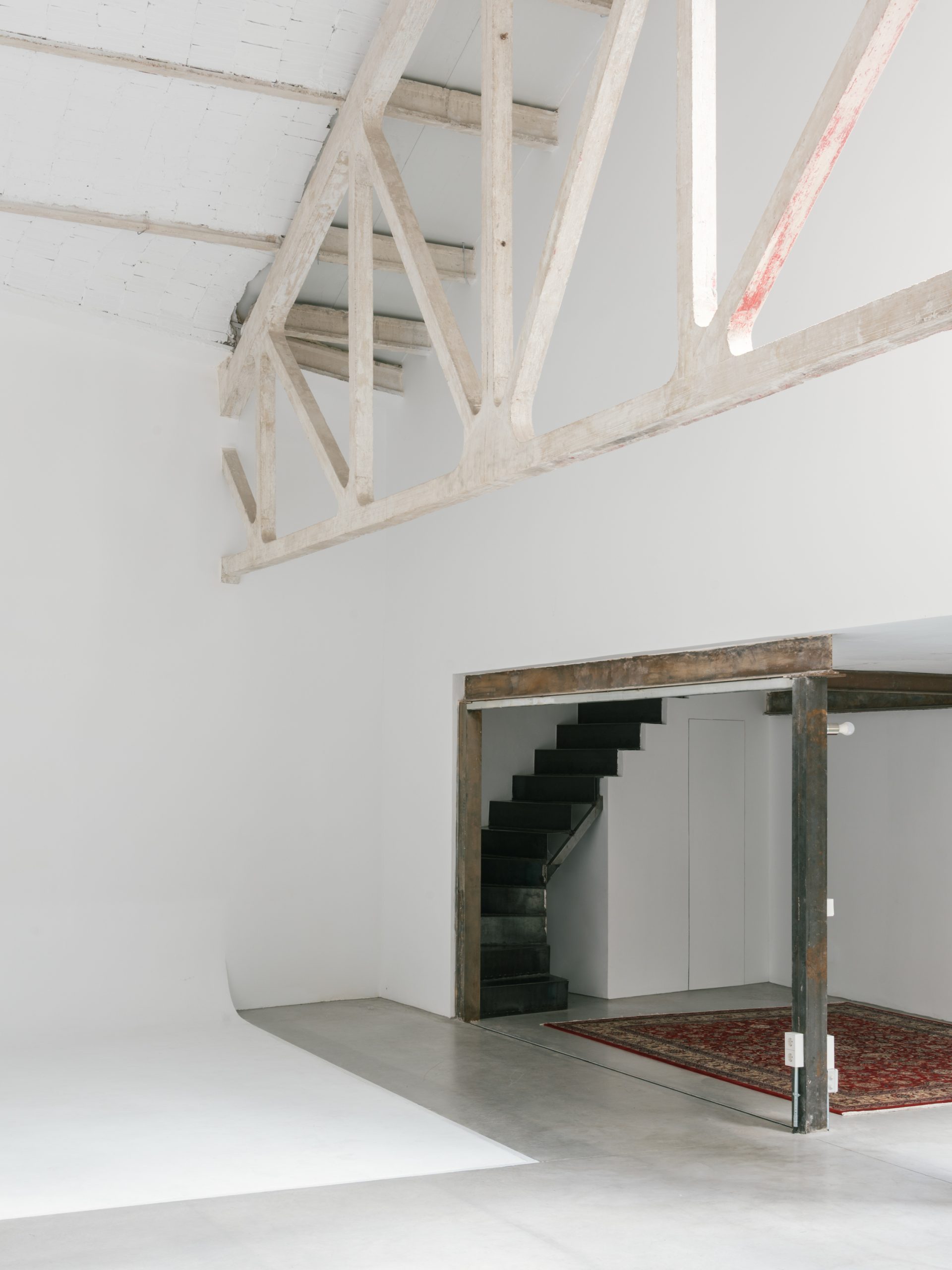 The domestic insertion sits beneath the existing roof structure.