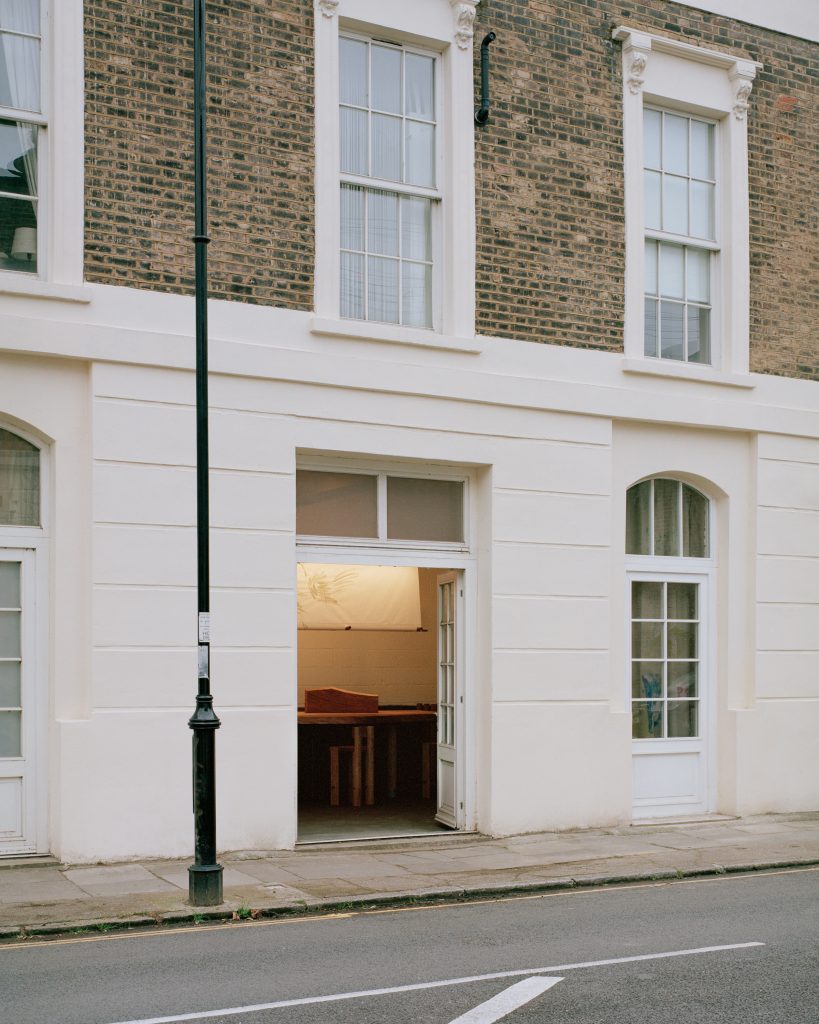 White-painted facade and entrance of Goodbye Horses pub in De Beauvoir Town, London