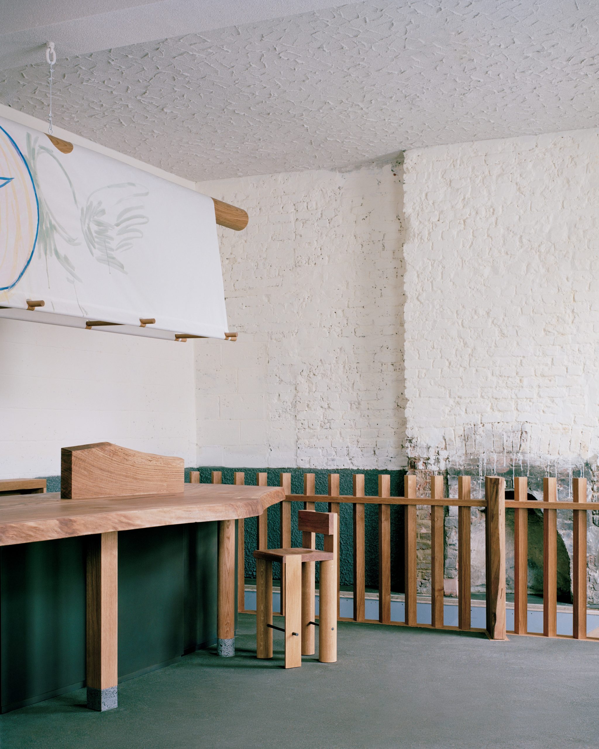 Low oak bar and timber seating inside Goodbye Horses pub