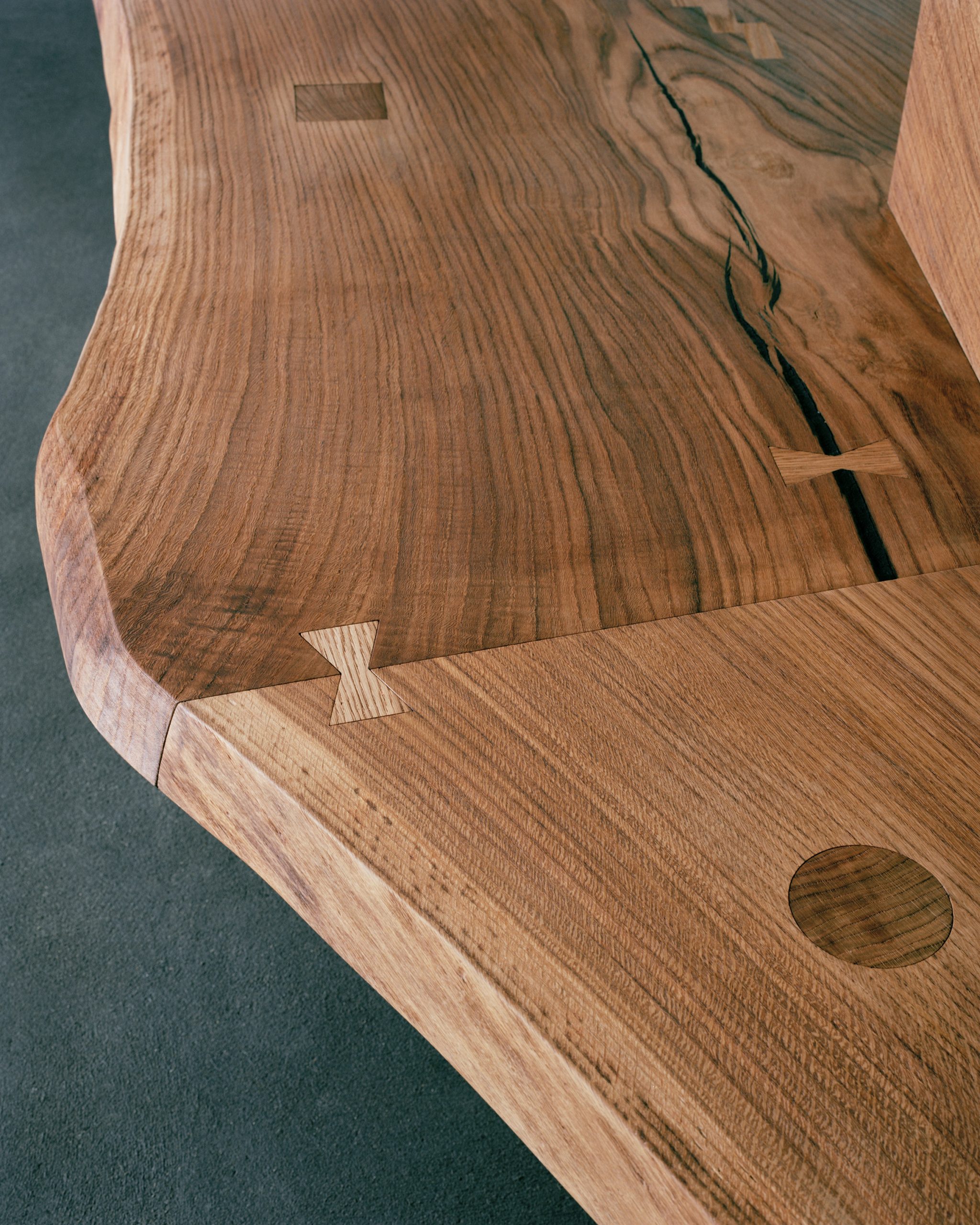 Close-up of the solid oak bar showing natural grain, cracks and butterfly joints