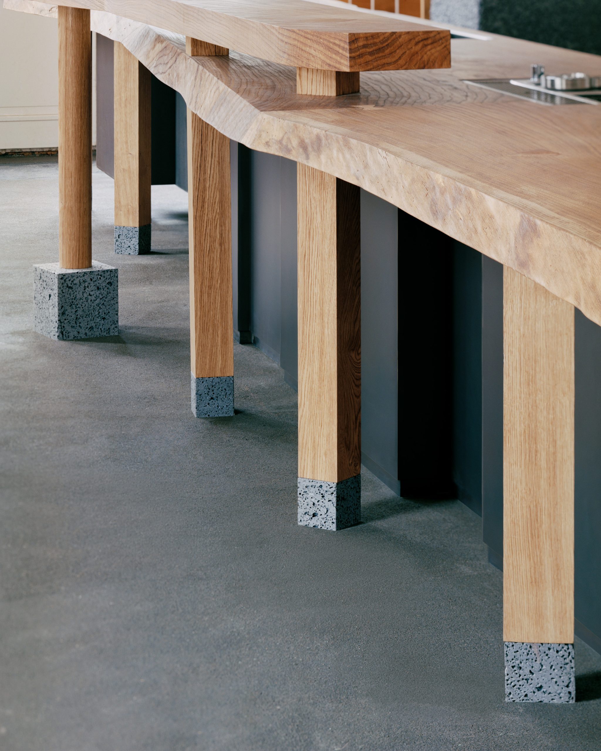 Oak bar supports finished with dark volcanic stone feet