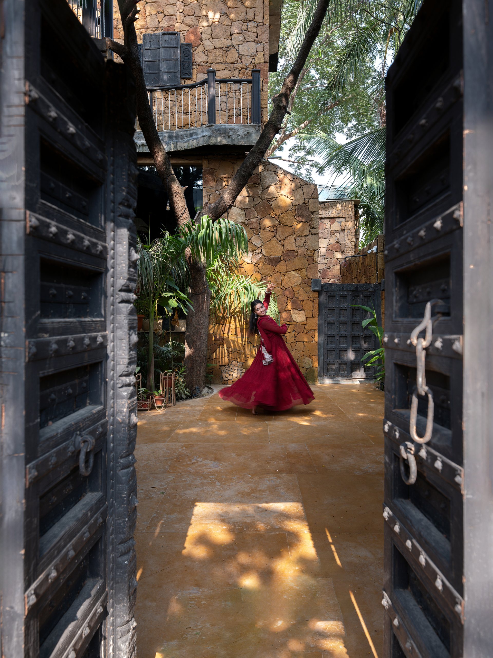 Entrance courtyard of Vedalila framed by dark timber gates