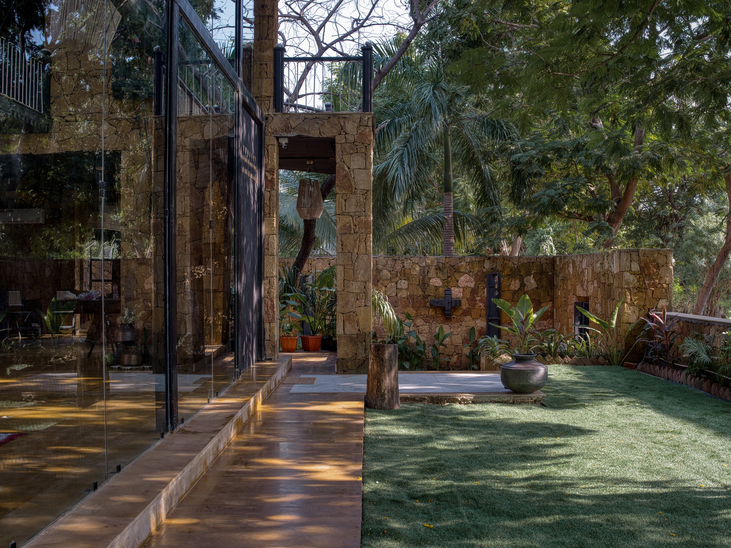 Glazed living spaces opening onto the garden at Vedalila