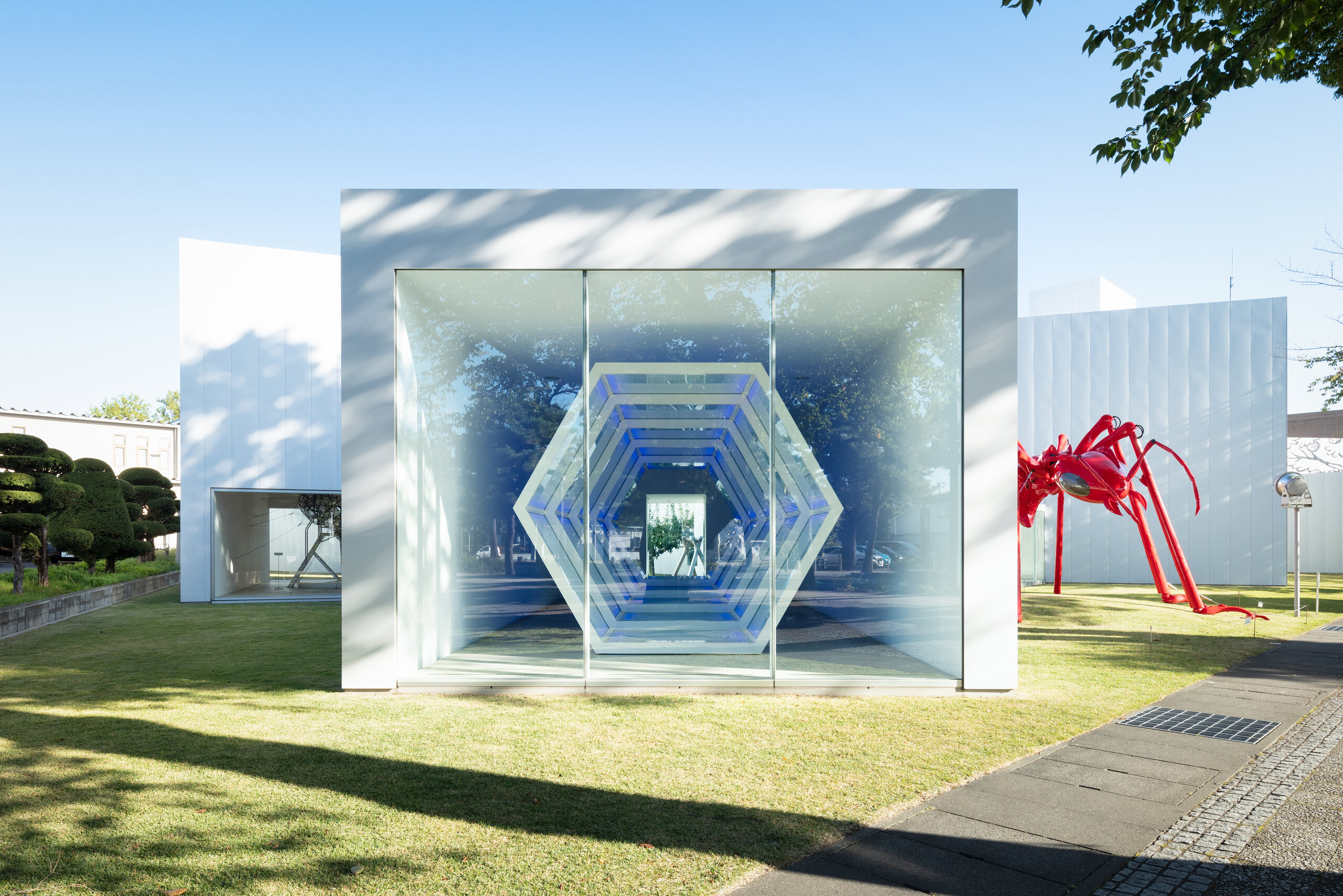 Glass-fronted artwork space opening onto the museum garden