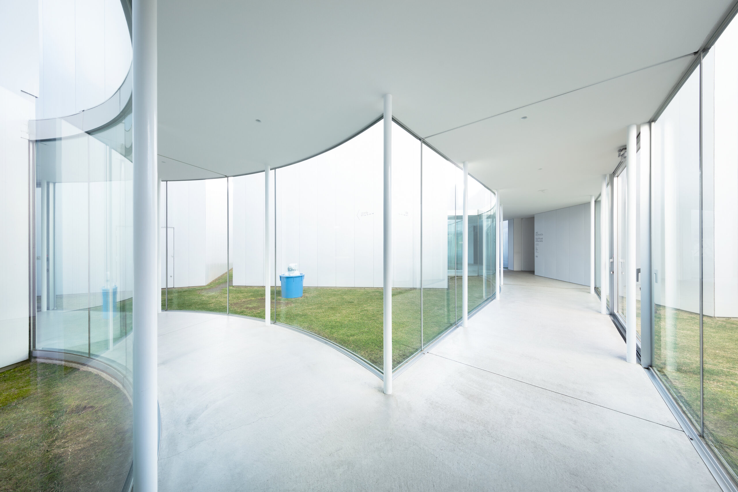 Interior route curving around a grass courtyard at Towada Art Center
