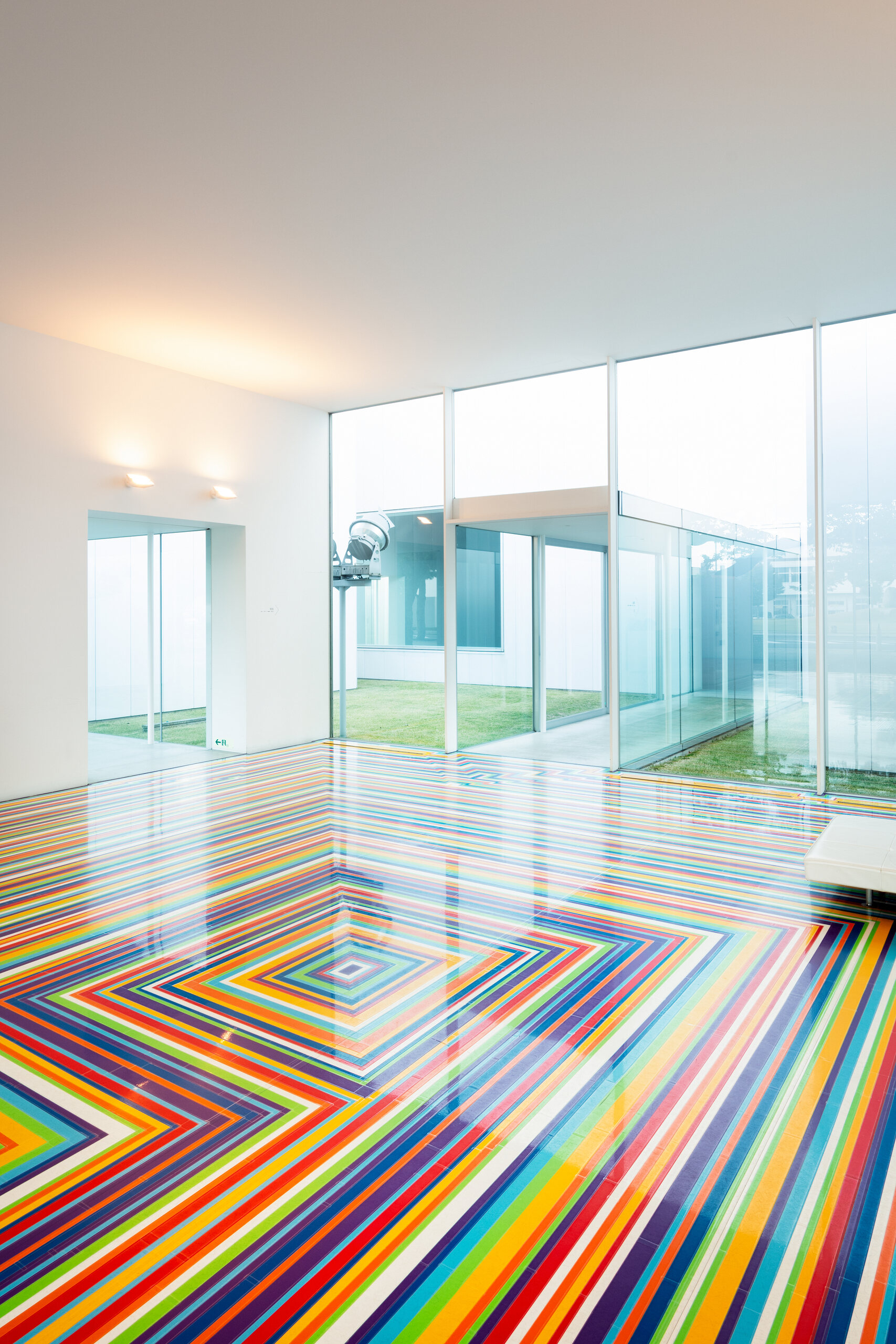 Colourful striped artwork extending across a gallery floor