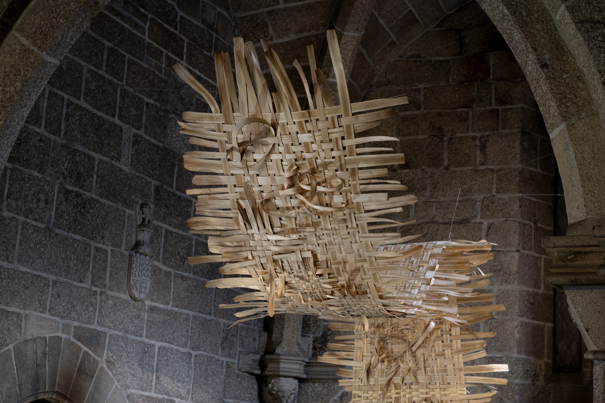 Braided rye straw woven into a shared chestnut framework by workshop participants