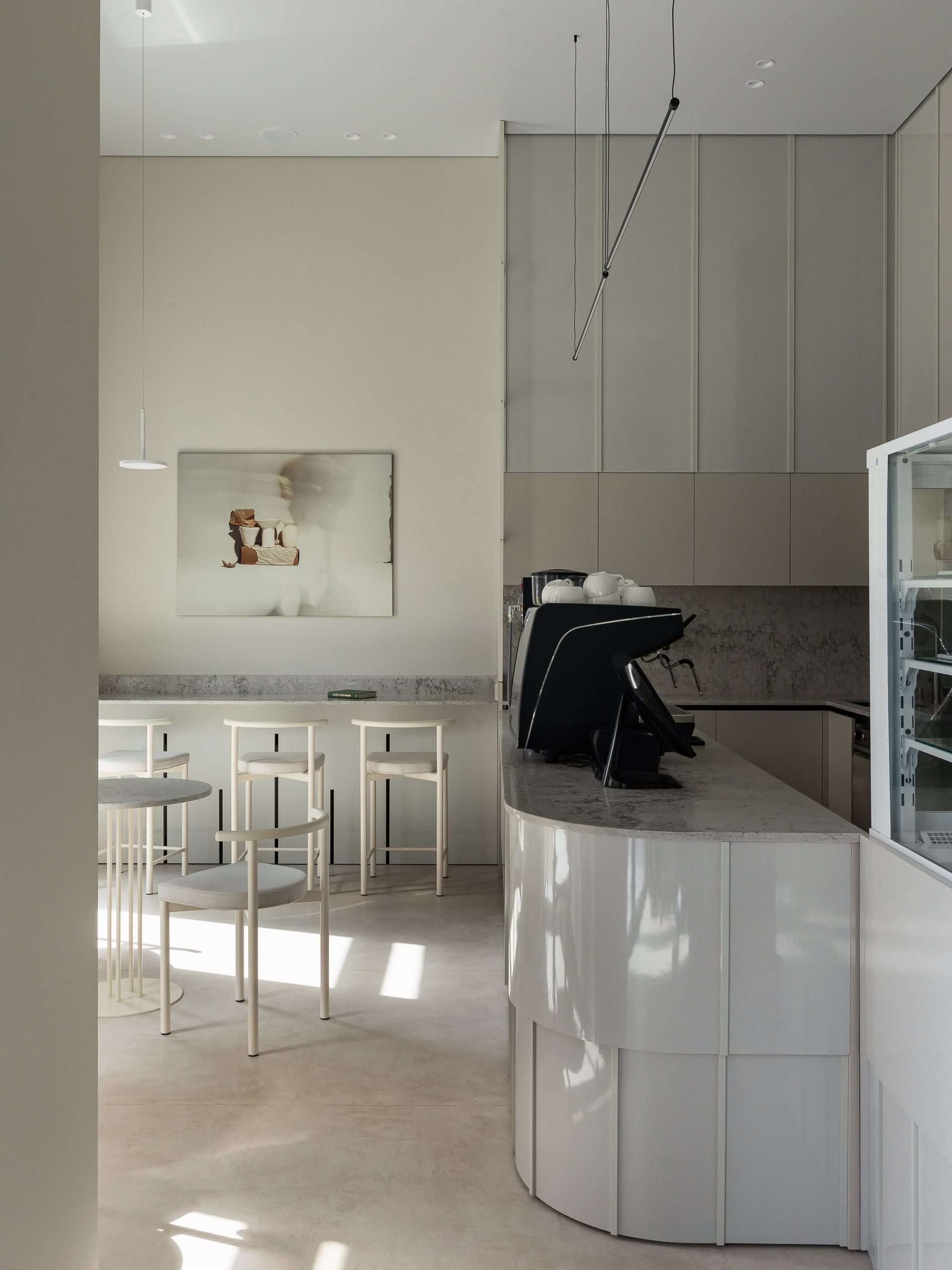 Cafe Goodies bar and white stools in Minsk, designed by Anna Lazar