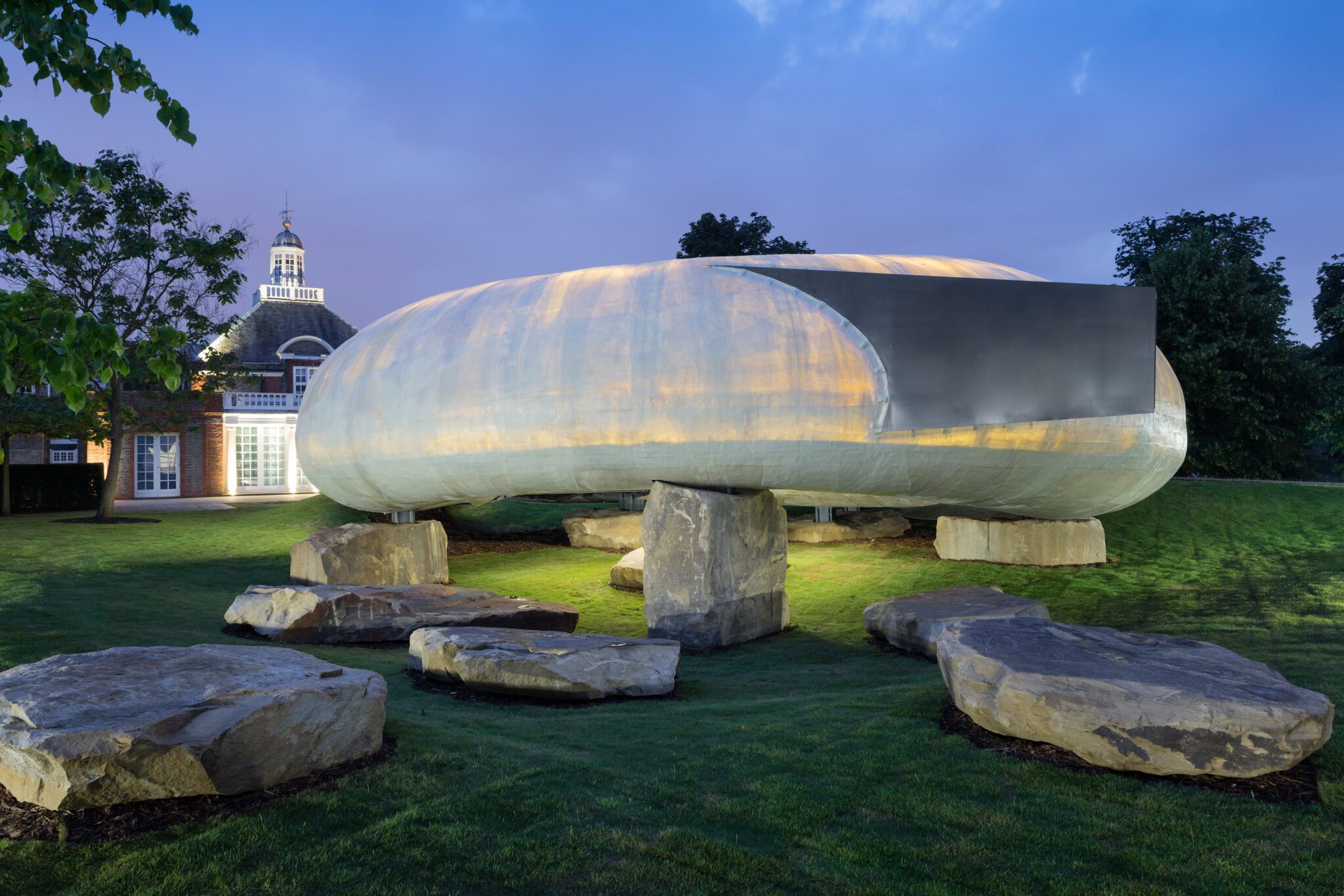 The 2014 Serpentine Pavilion by Smiljan Radić, an organic shell-like form raised on boulders.