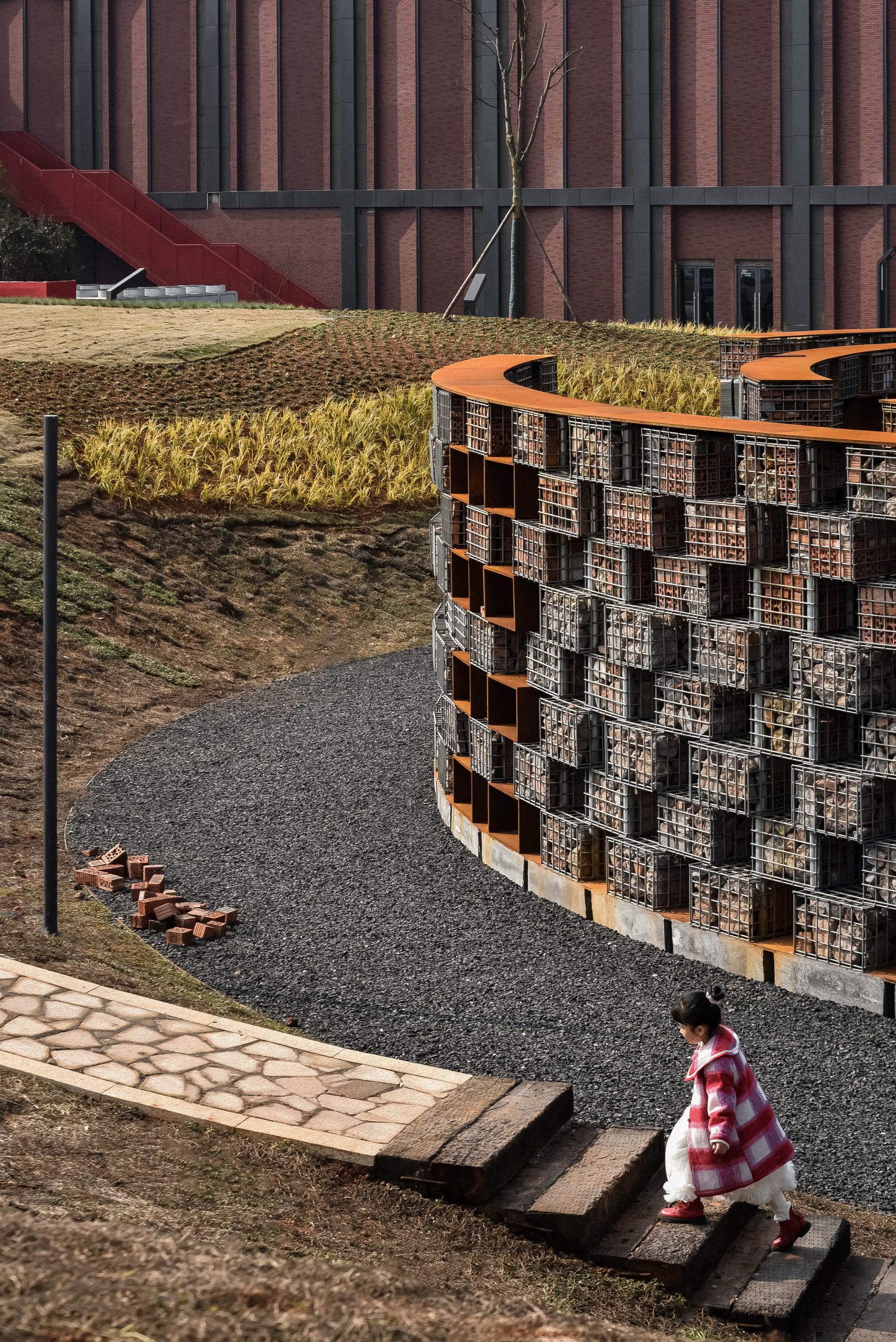 A visitor explores the museum in dialogue with the surrounding industrial landscape