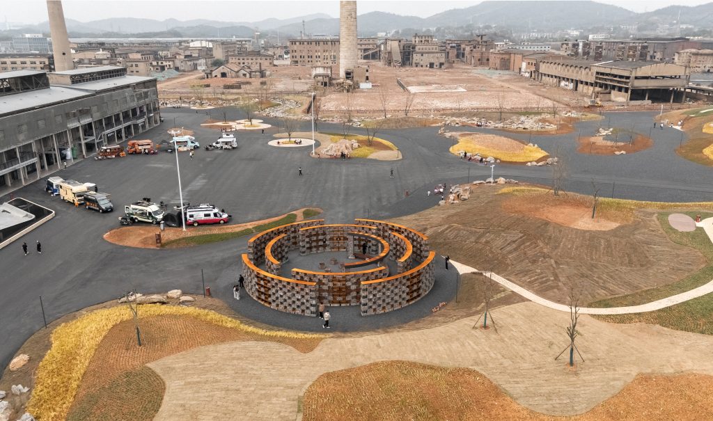 High-angle aerial view of the circular museum within the industrial heritage site