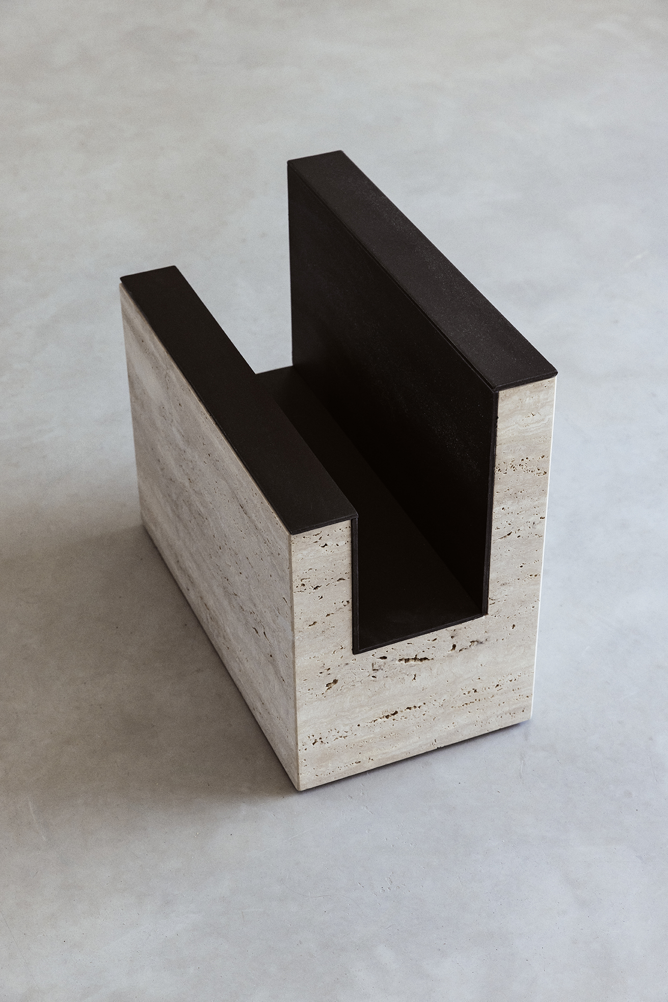 Detail of the Sum travertine magazine rack