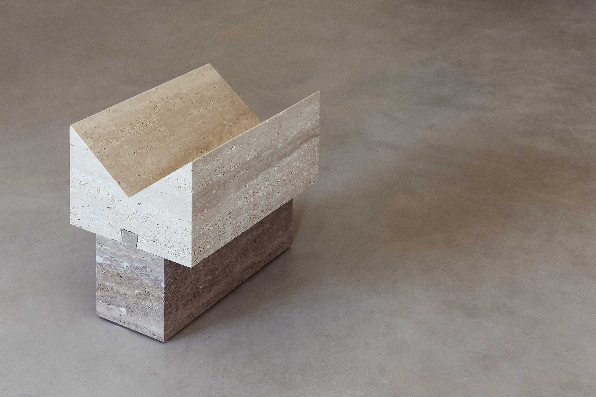 Ori magazine rack in contrasting travertine