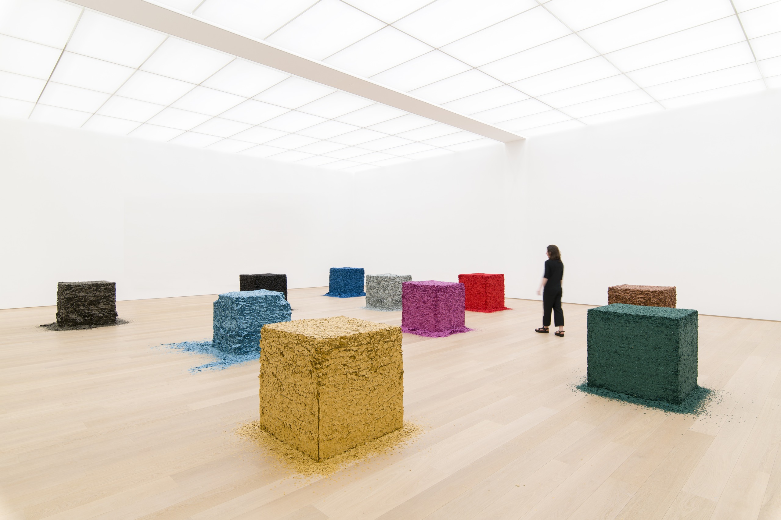 Coloured confetti blocks arranged across a museum gallery floor.