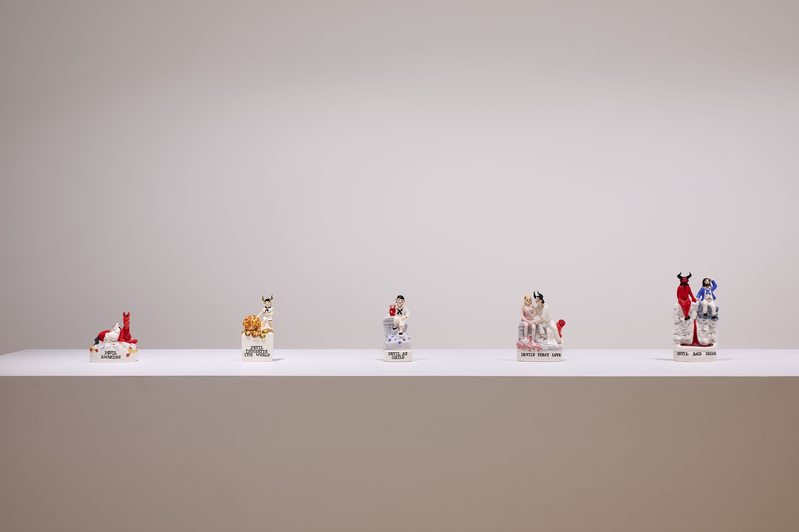 Glazed ceramic figures from Nick Cave’s The Devil – A Life displayed in a row.