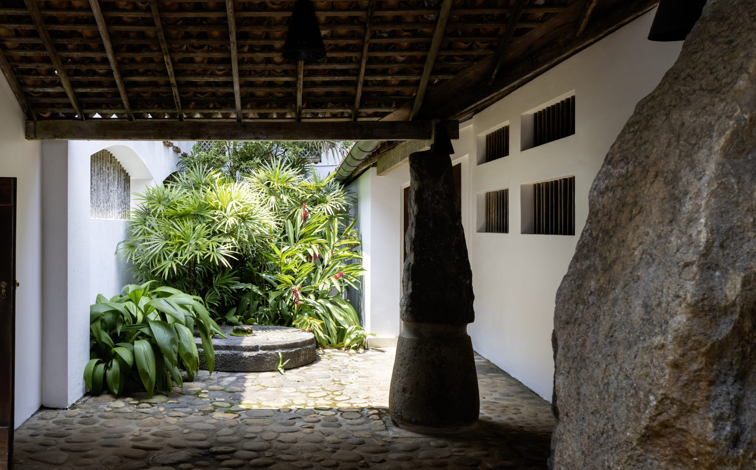 Entry portal with inverted grinding stones at the House for Osmund and Ena de Silva