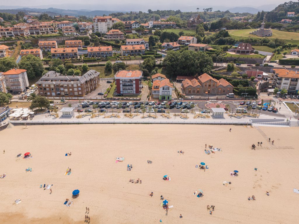 Aerial view of the Comillas waterfront promenade and beach