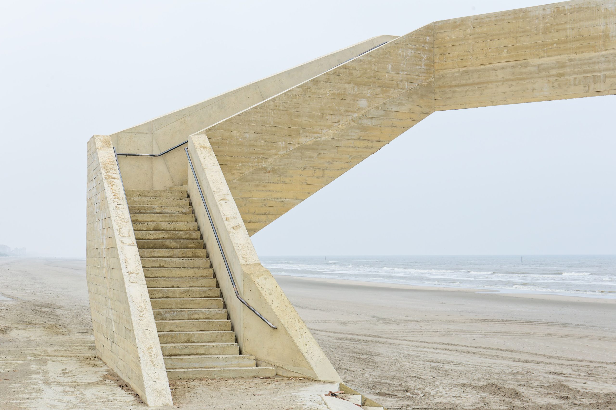 A stair flight climbs through the sloping concrete structure.