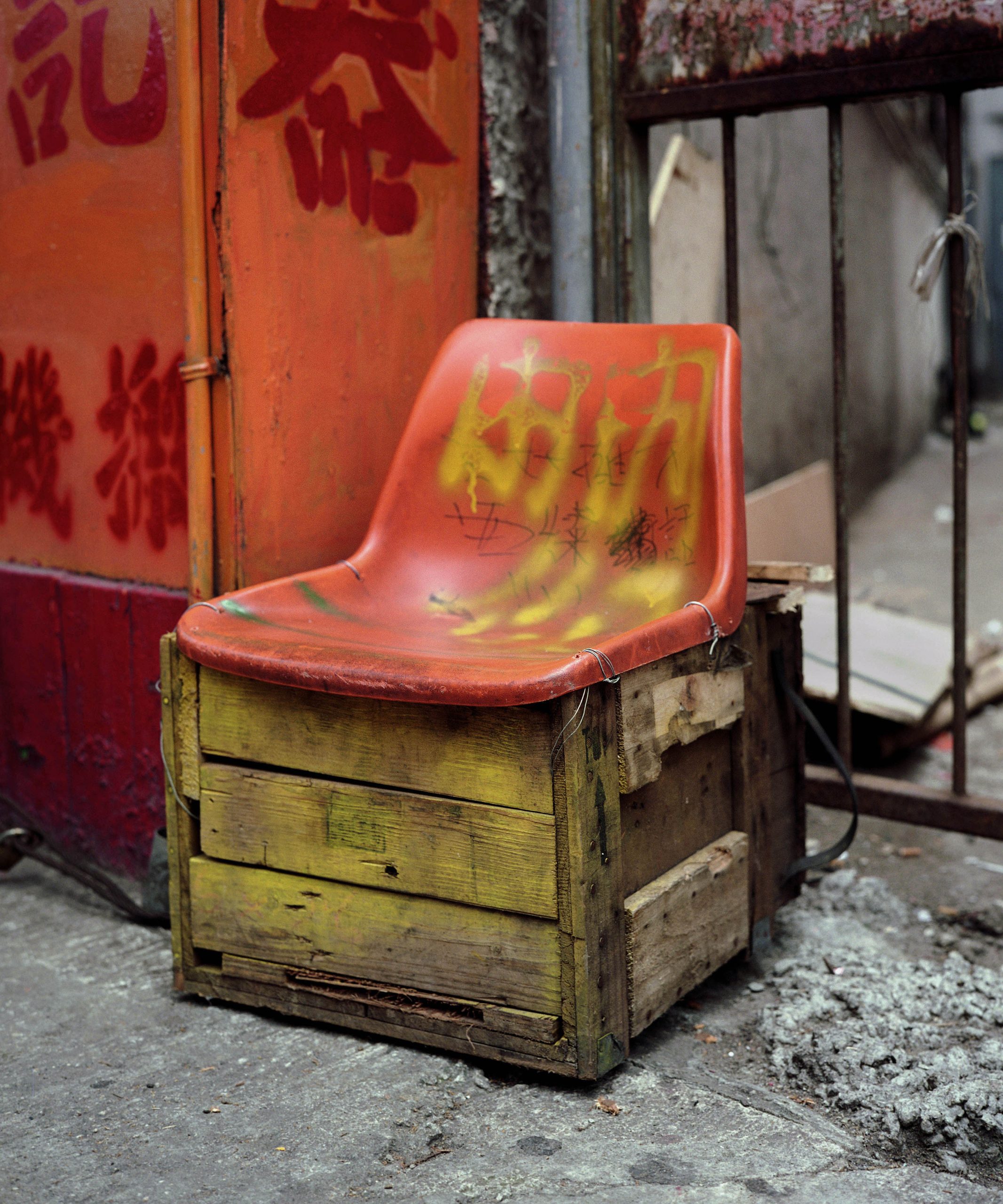 Michael Wolf, Bastard Chairs. A moulded plastic seat is supported by a wooden crate.