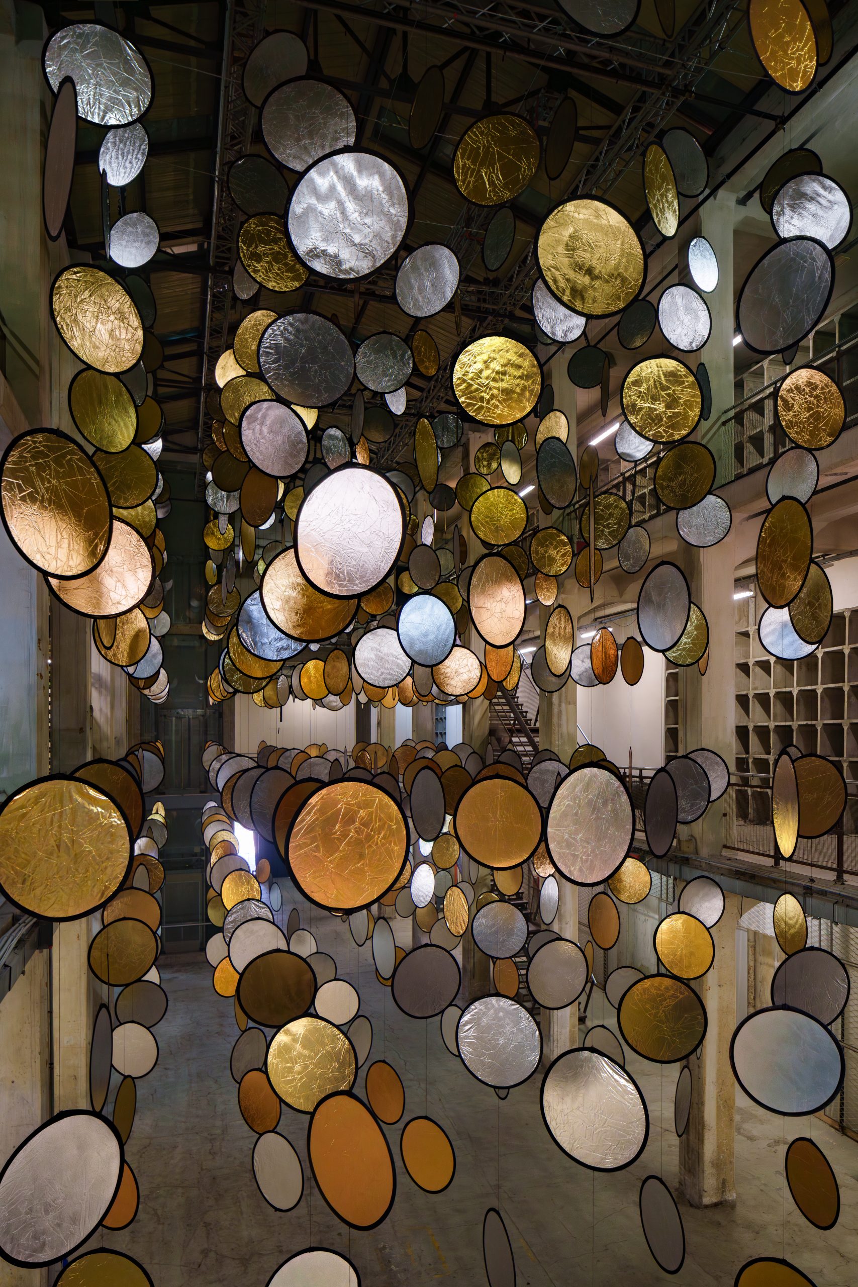Gold and silver discs seen from above in the three-level atrium