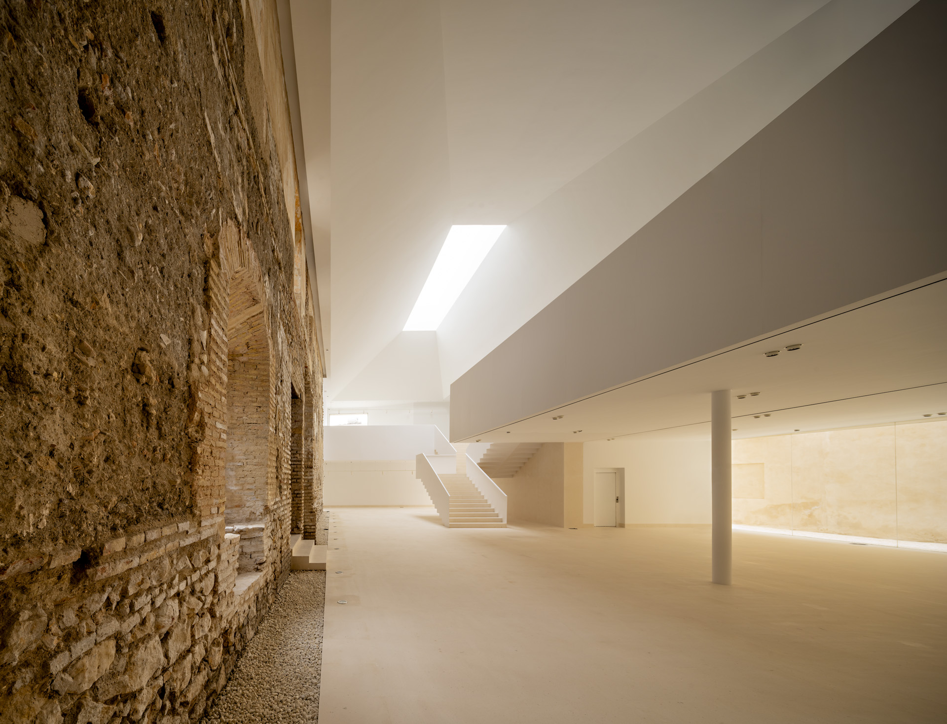 Historic masonry wall beside the museum's new gallery and rooflight