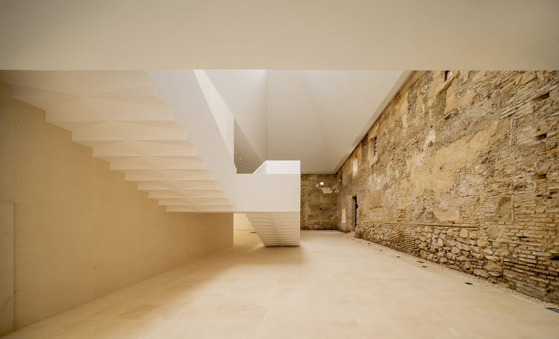 New upper gallery beside an exposed historic wall