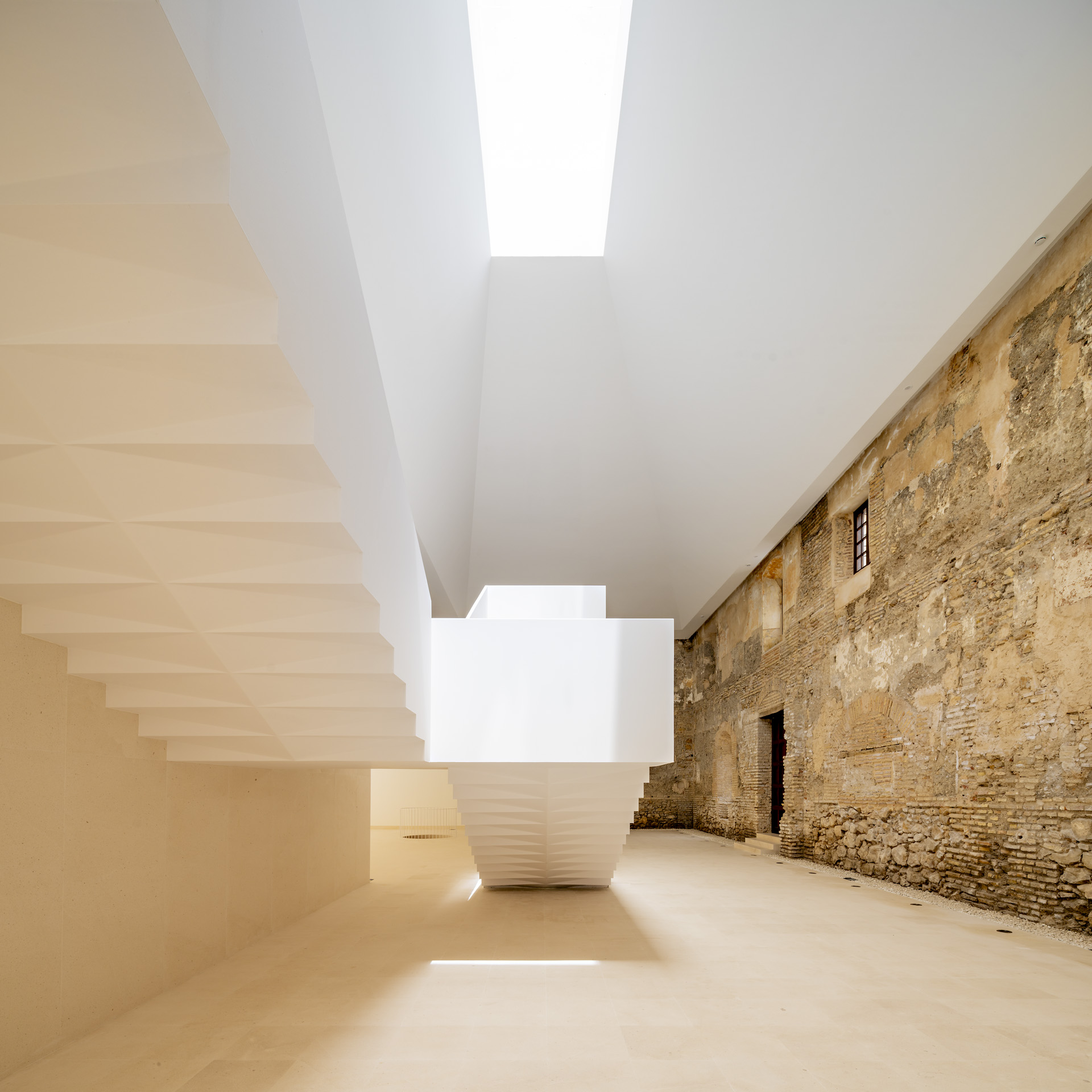 View beneath the new stair beside historic masonry