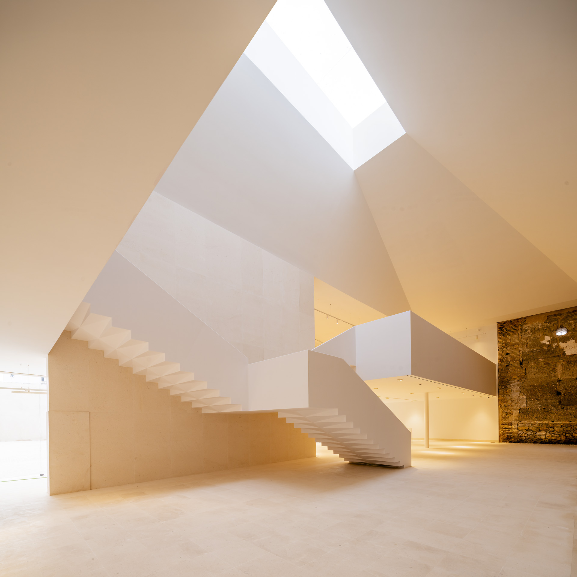 Sculptural staircase and rooflight in the museum atrium