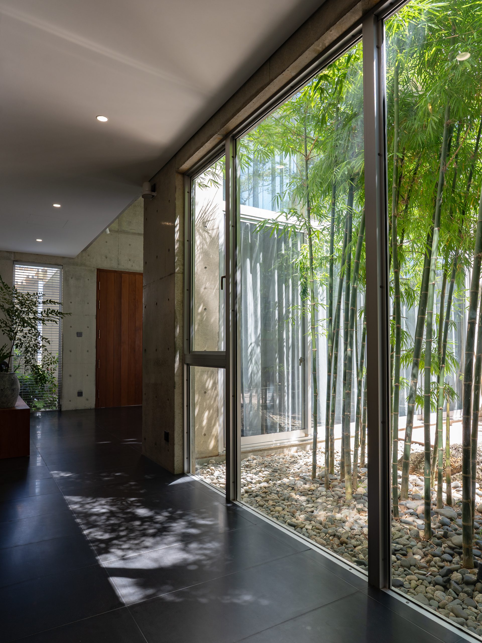 Ground-floor corridor beside the bamboo courtyard, House K by HGAA