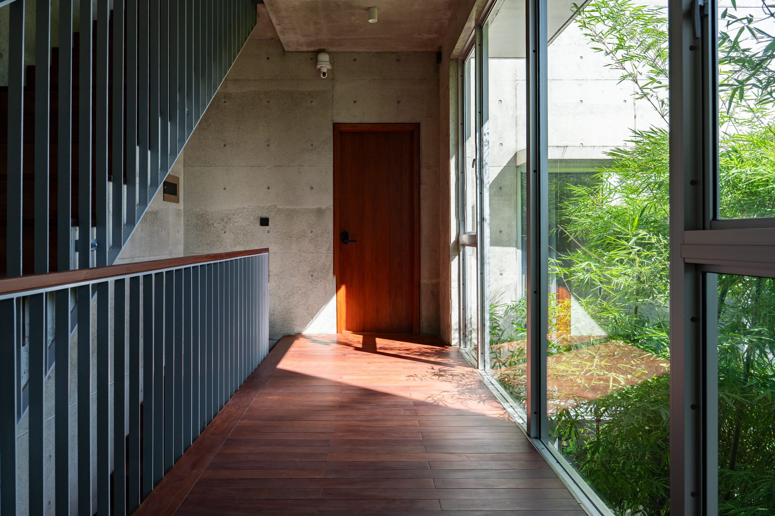 Upper landing overlooking bamboo, House K by HGAA